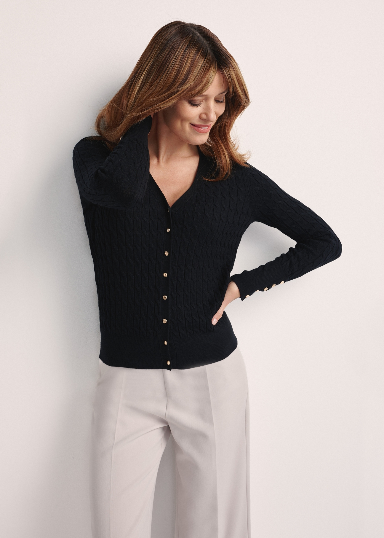 Black women's cardigan with buttons KARDT-0044A-99(Z25), front view of the product on the model, half of the silhouette visible.