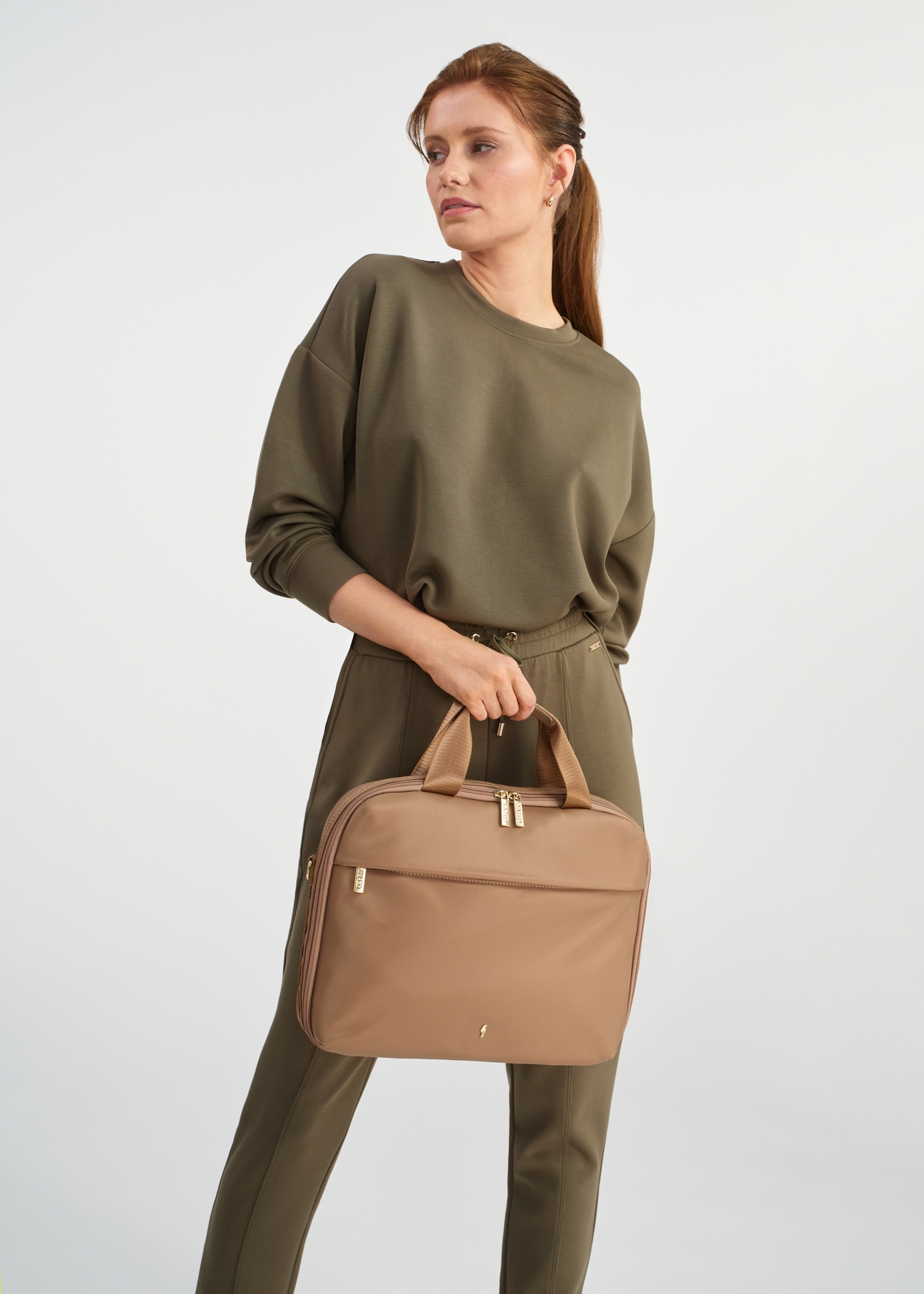 Beige women's laptop bag TOREN-0306-81(W25) - view of a model on a white background. Half of the silhouette visible.