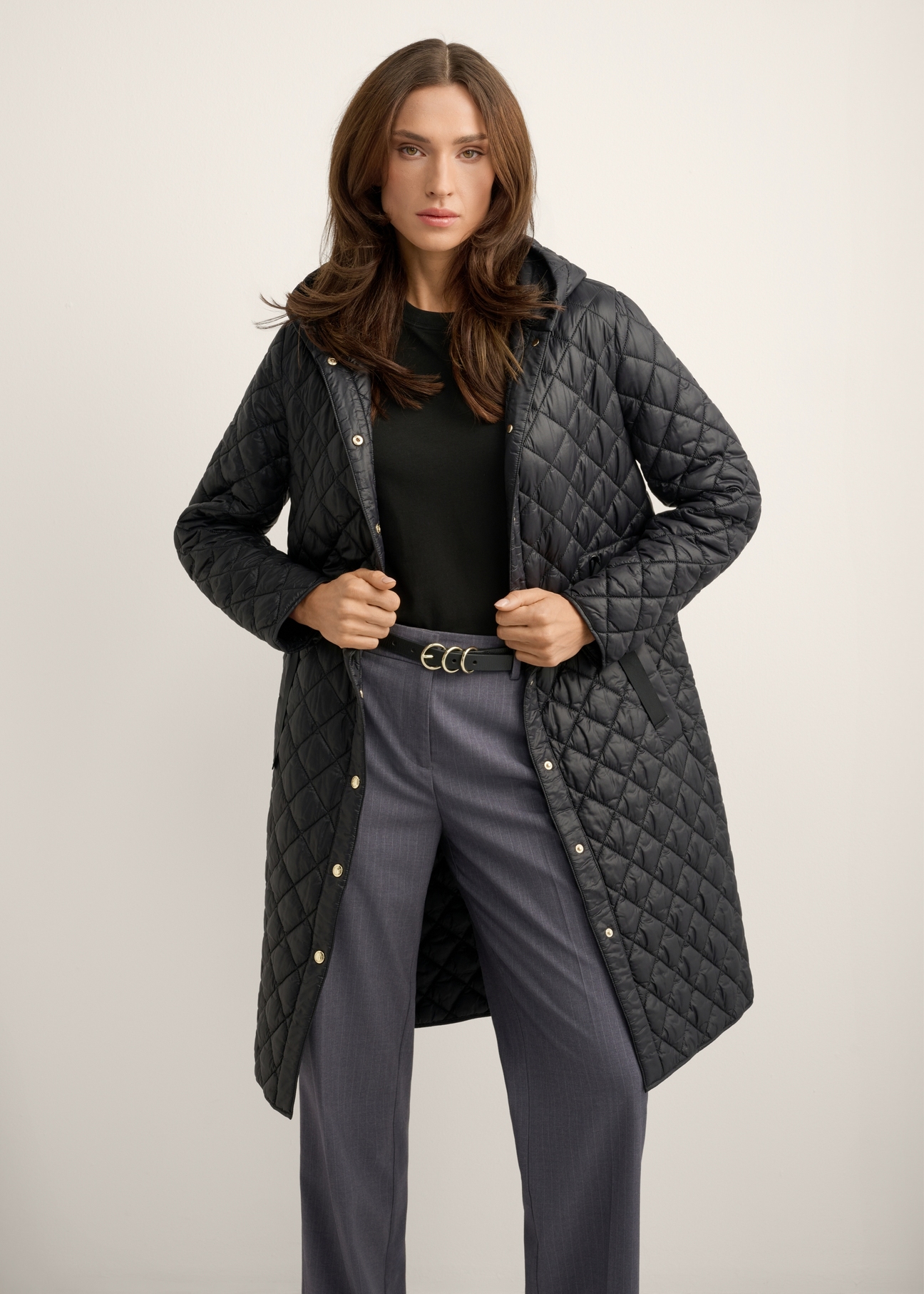 Women's black quilted jacket KURDT-0680-99(Z26), front view of the product on the model. Half of the silhouette visible.