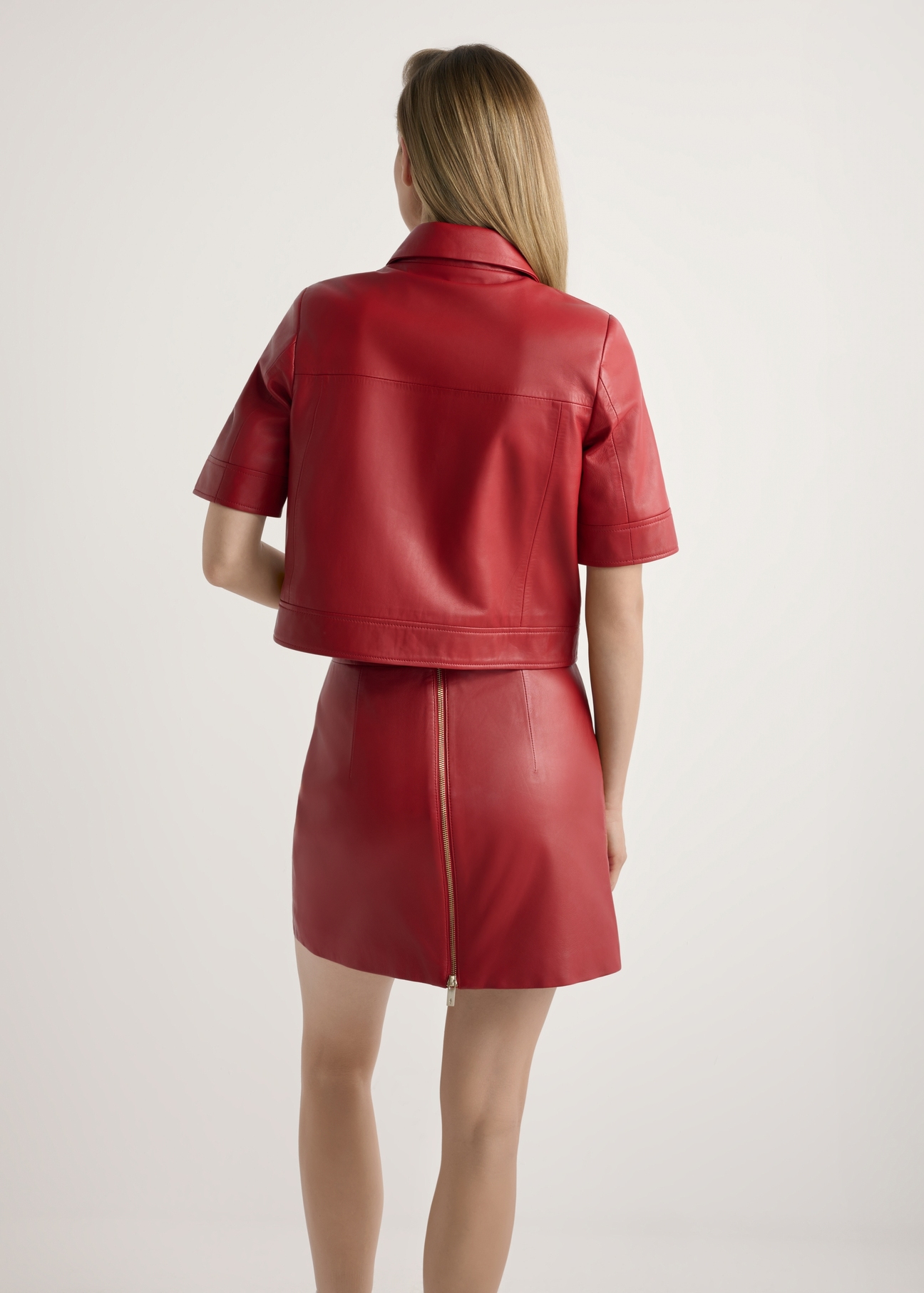 Red women's leather shirt KOSDS-0007-4B(W26), product view from the back on the model, the whole silhouette is visible.
