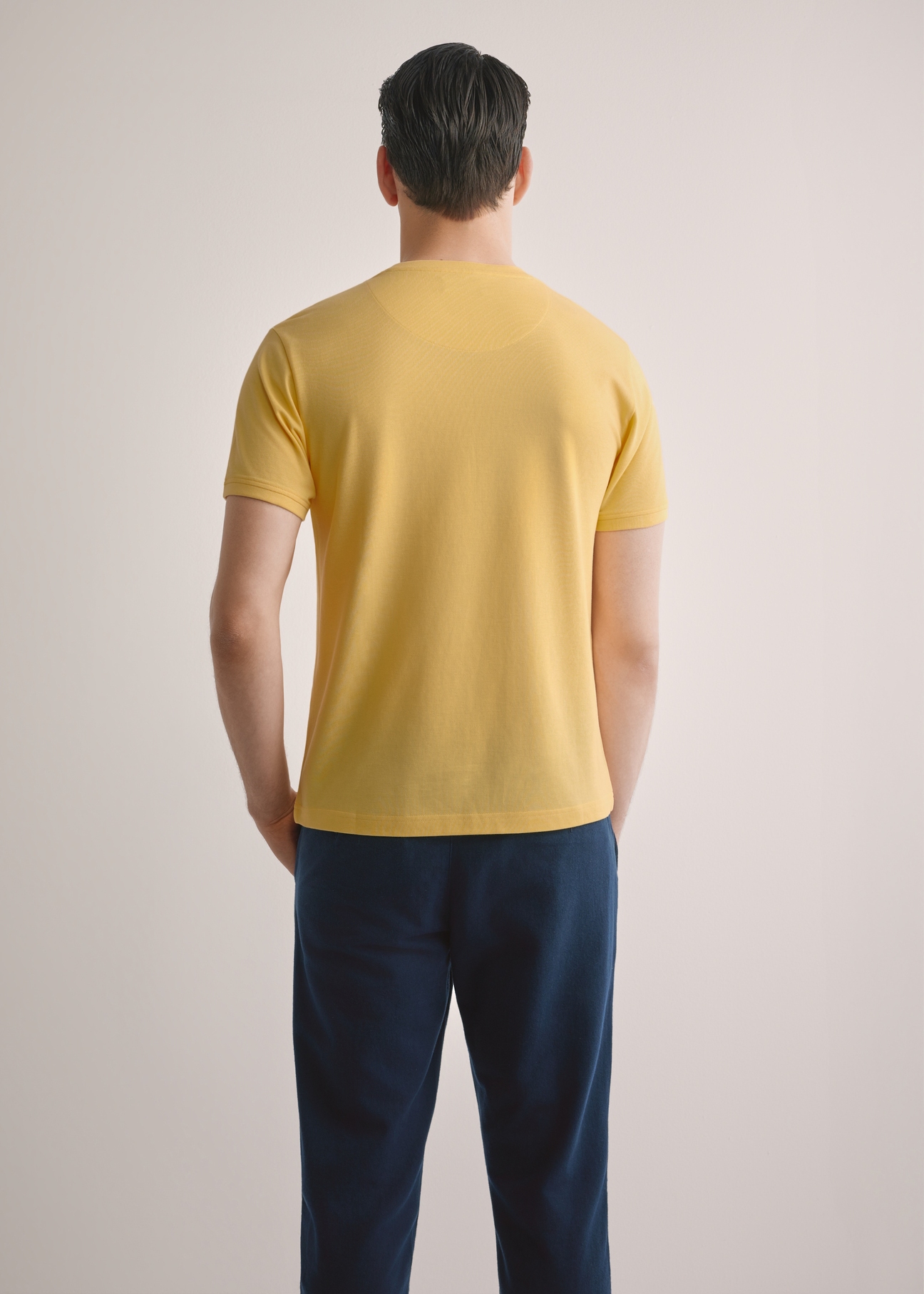 Men's yellow cotton t-shirt TSHMT-0136-2B(W26), back view of the product on the model. Half of the silhouette visible.