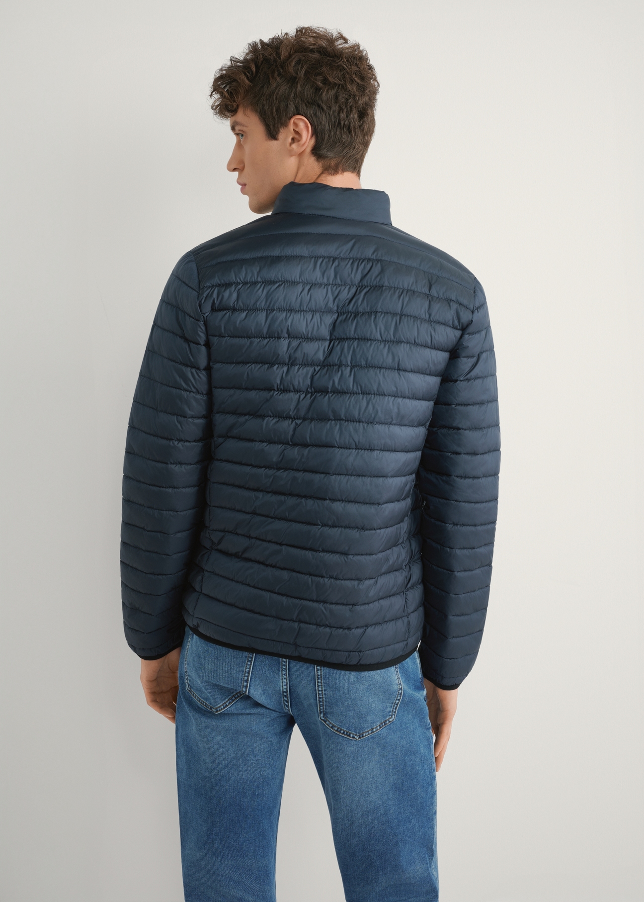 Men's navy quilted jacket KURMT-0421-7D(W26), product view from the back on the model. Half of the silhouette visible.