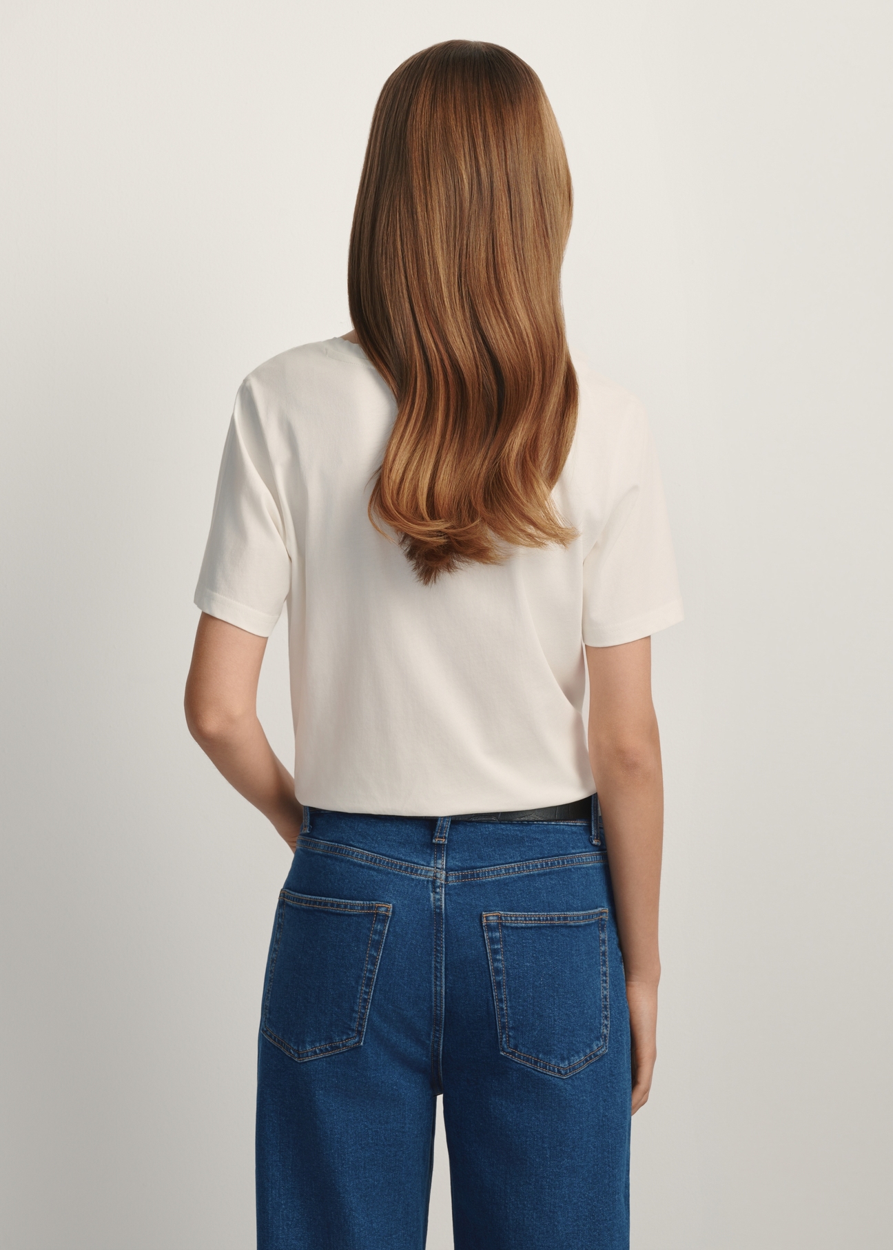 Cream basic women's T-shirt TSHDT-0120-0B(W26) - back view of the product on a model, against a white background. Knee-length silhouette visible.