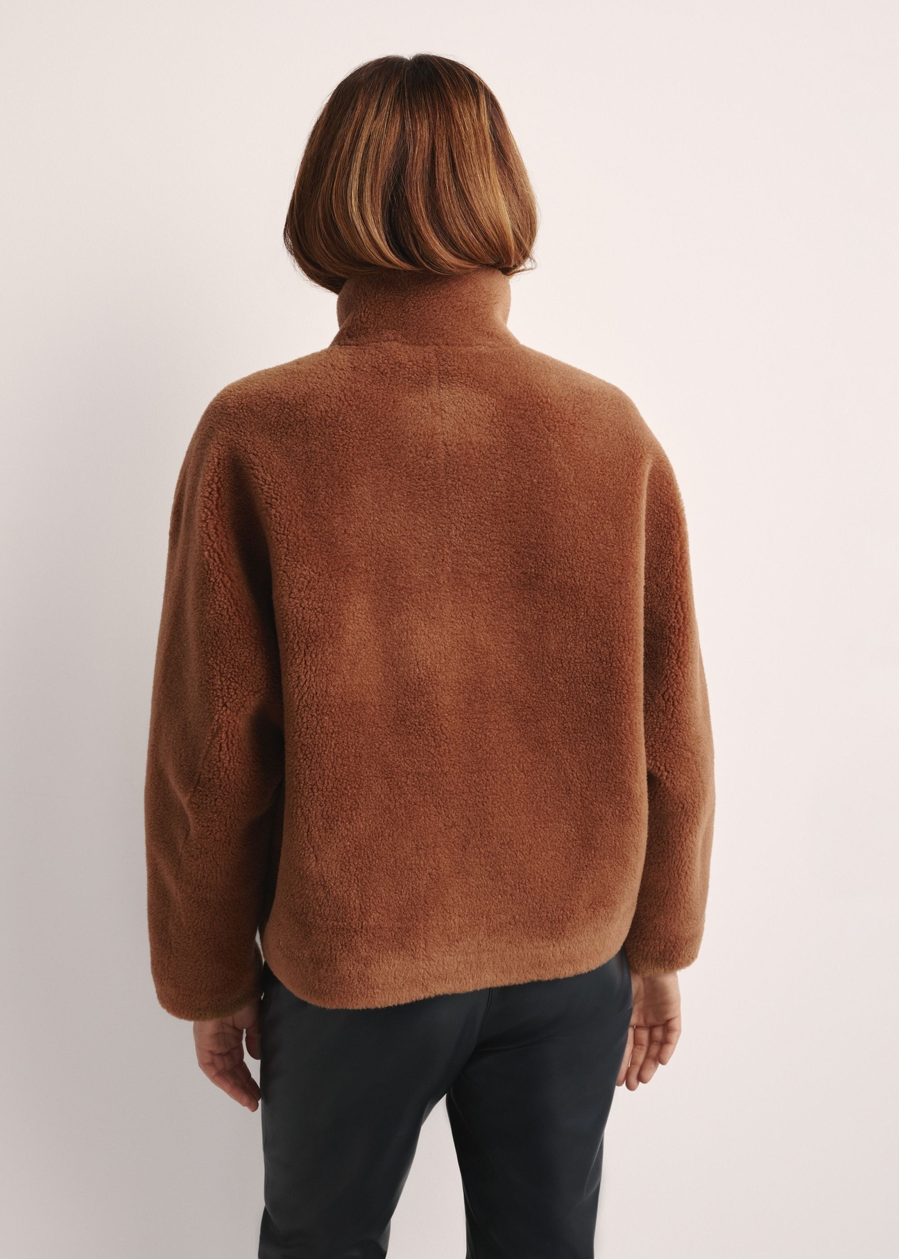 Brown woolen women's fur coat FUTDW-0033-1D(Z26), product view from the back on the model. Half of the silhouette visible.