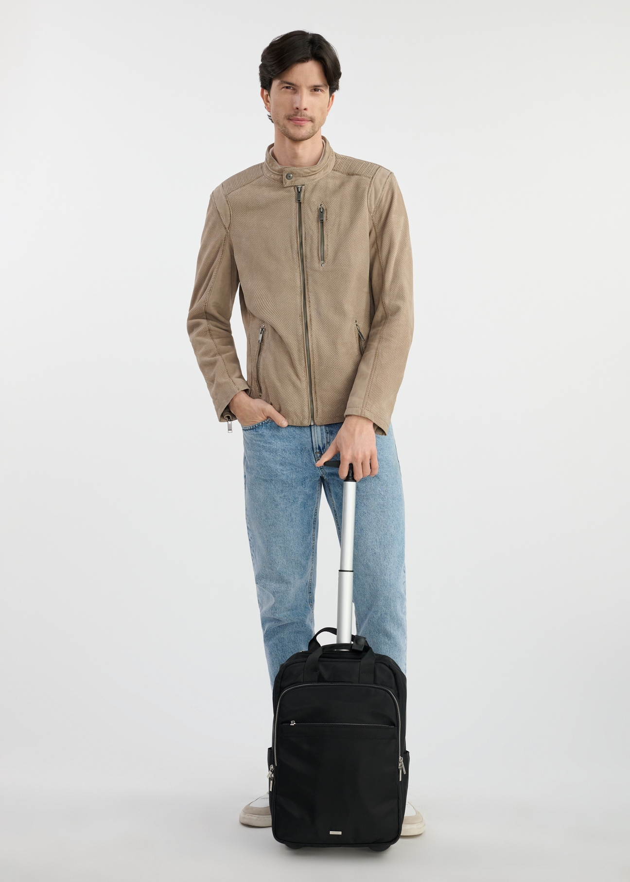 Black travel backpack - small suitcase TOREN-0307-99(W25), front view of the product on the model. The whole silhouette is visible.