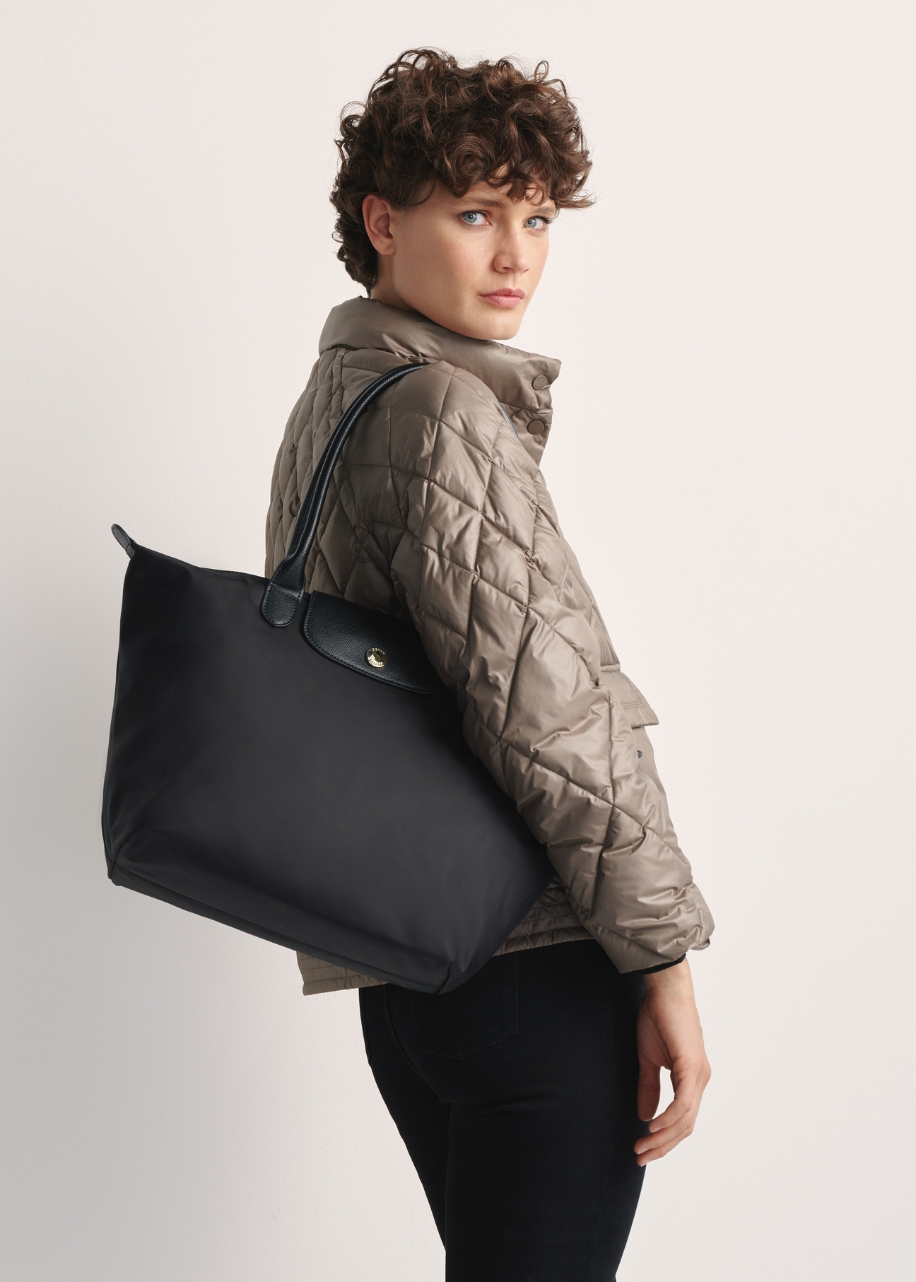 Black fabric bag TOREN-0317-99(Z25) - front view of the product on a model against a white background. Half of the silhouette visible from the side.
