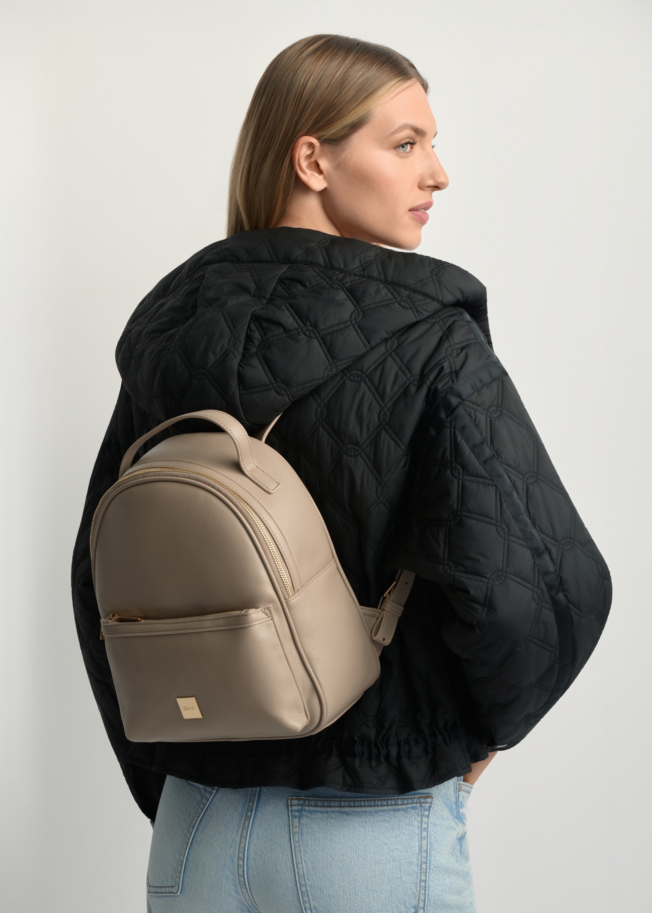 Beige women's medium backpack TOREC-0920-1D(W26), product view on model's back. Half of silhouette visible.