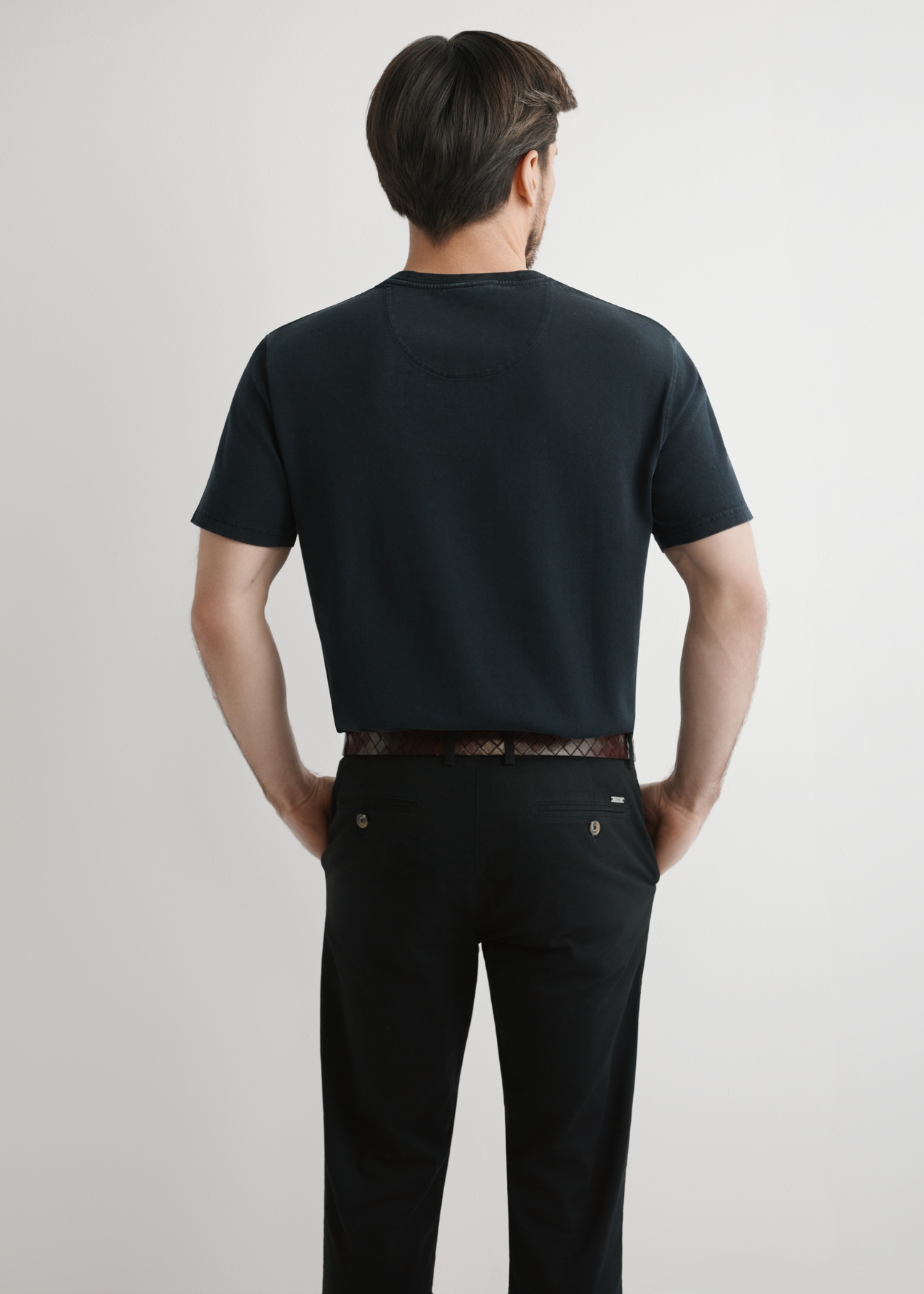 Men's black cotton T-shirt TSHMT-0140-99(W26), back view of the product on the model. Half of the silhouette visible.