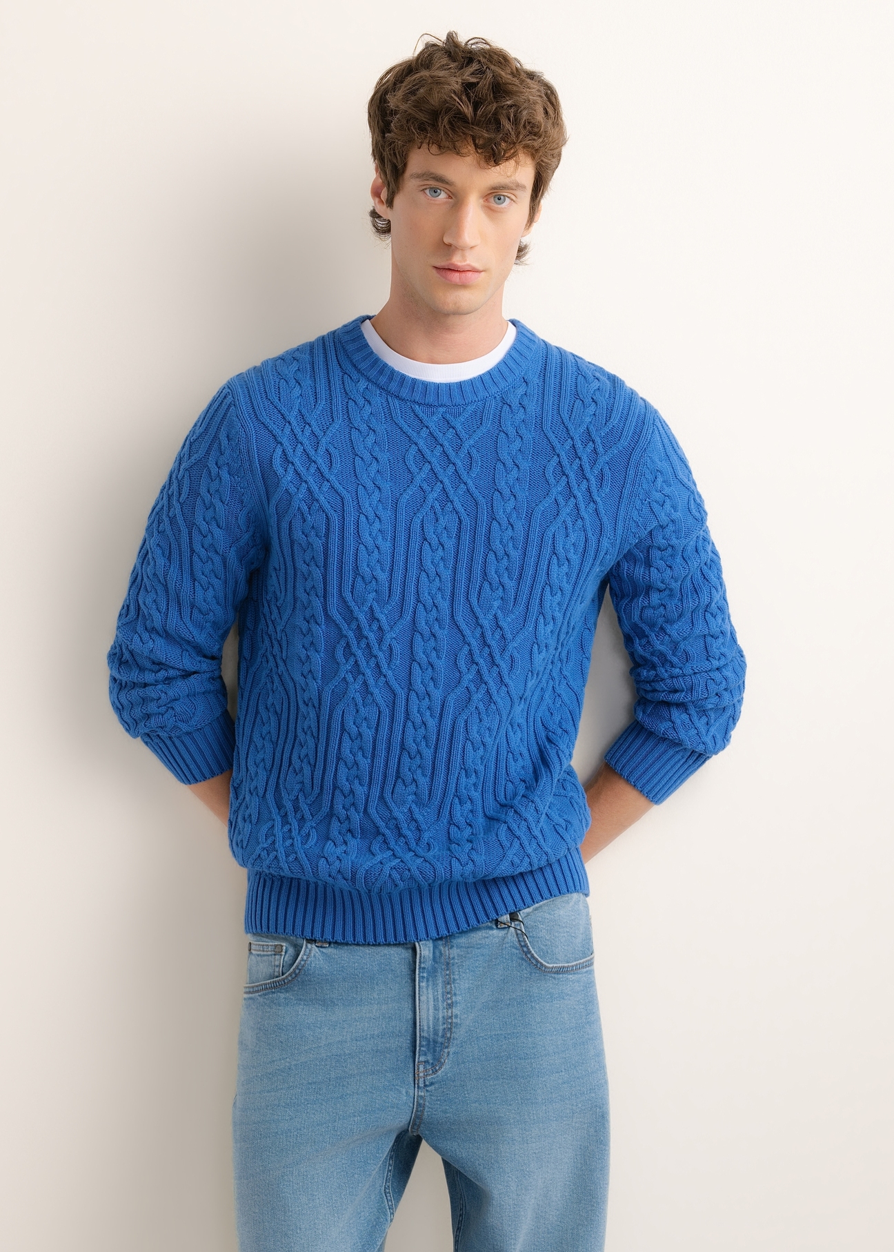 Dark blue men's sweater with decorative weave SWEMT-0205-7C(Z26), front product view on model. Half silhouette visible.