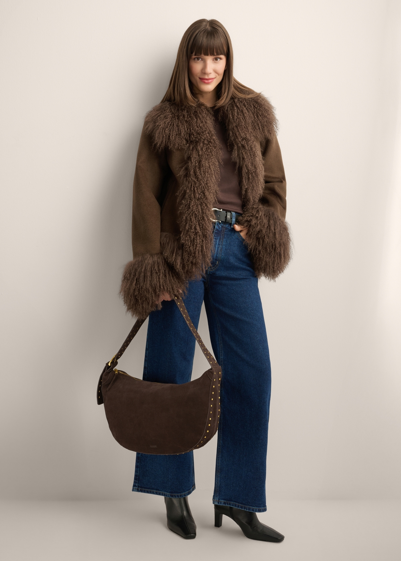 Brown suede women's hobo bag TORES-1384-1I(Z26) - front view of the product, held by the model, against a white background. Full body silhouette visible.