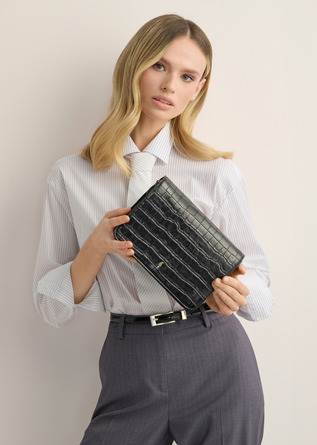 Black leather croco women's handbag TORES-1324-9G(Z26), product view in model's hands. Half of silhouette visible.