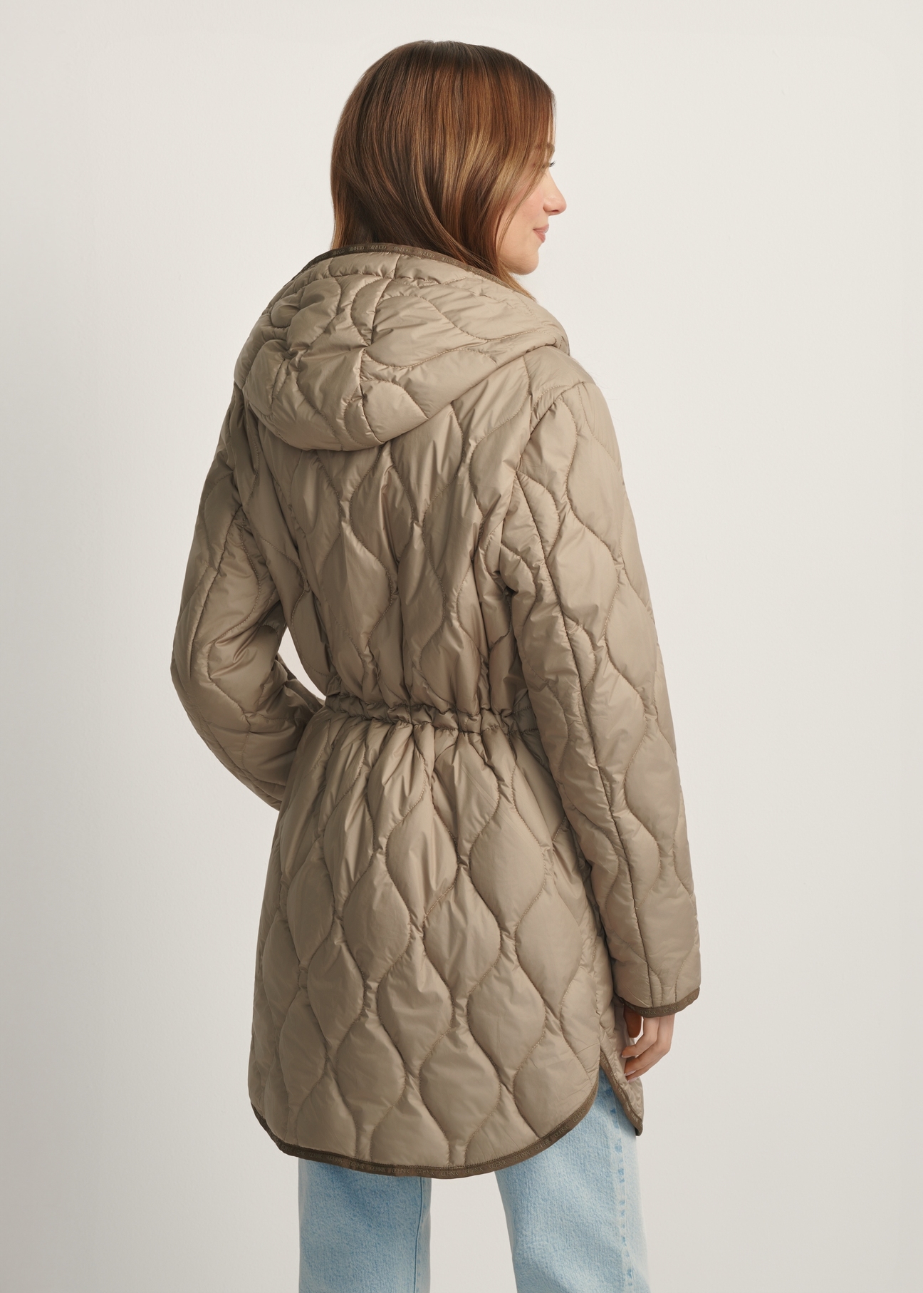 Dark beige women's quilted jacket KURDT-0654-1B(W26), back view of the product on the model. Half of the silhouette visible.