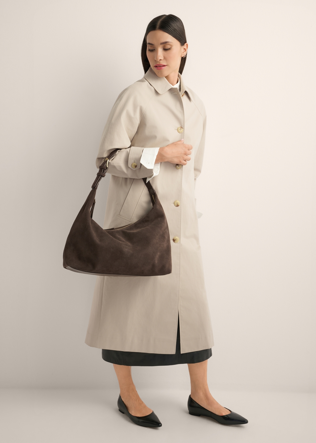 Brown suede handbag TORES-1404-1I(Z26) - front view of the product, held by the model, against a light background. The entire silhouette is visible.