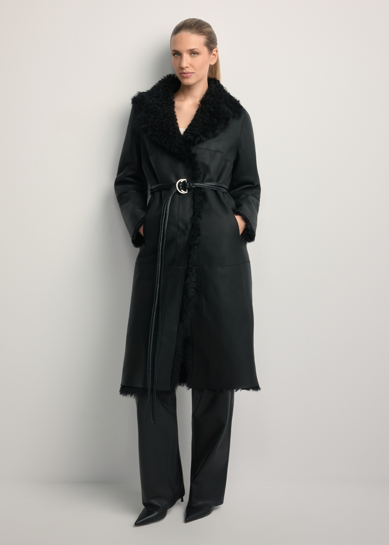 Black double-sided women's sheepskin coat KOZDS-0091-1395(Z25), front view of the product on a model. Full body visible.