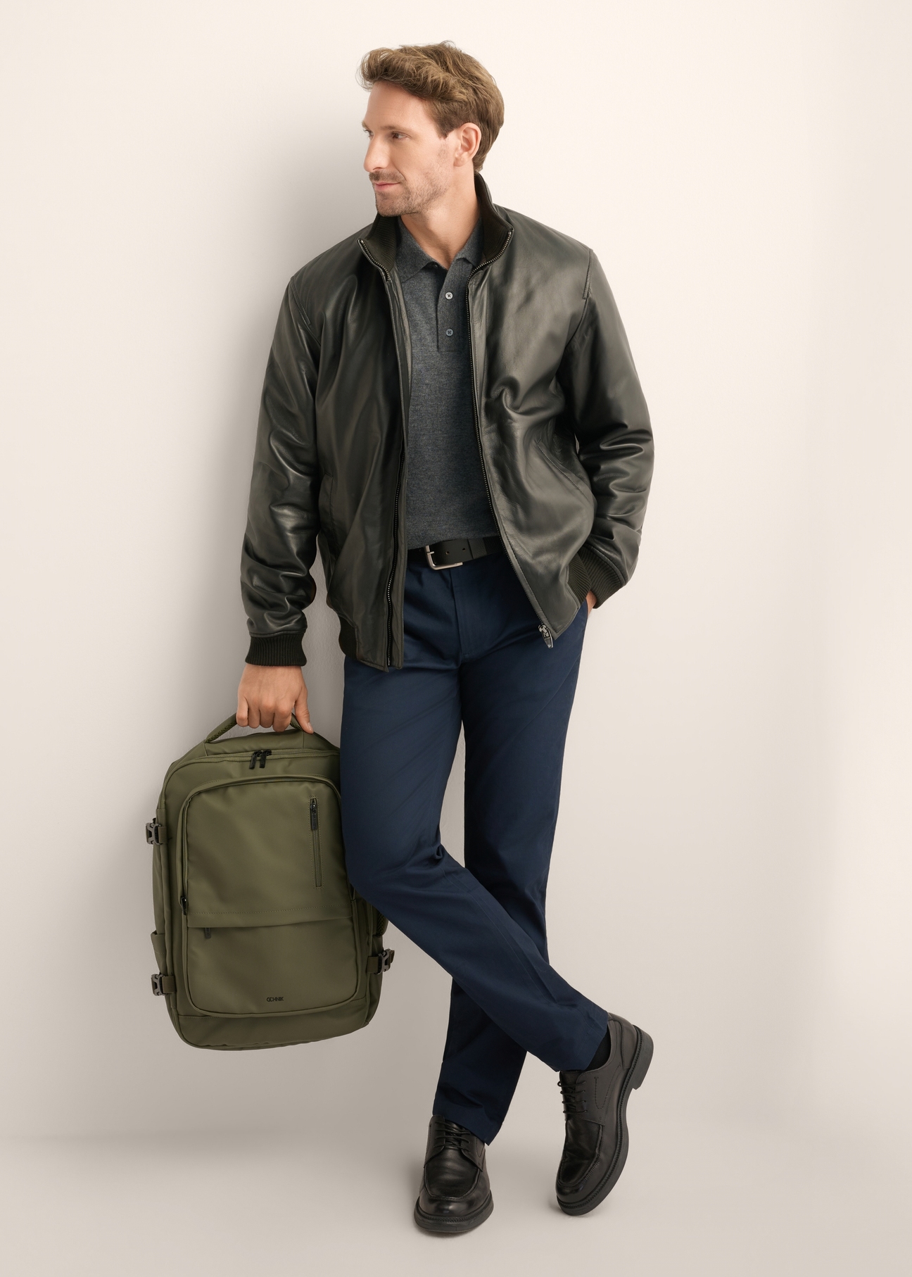 Large khaki travel backpack PLCMN-0018-8D(Z26), front view of the product on the model, the entire silhouette is visible.