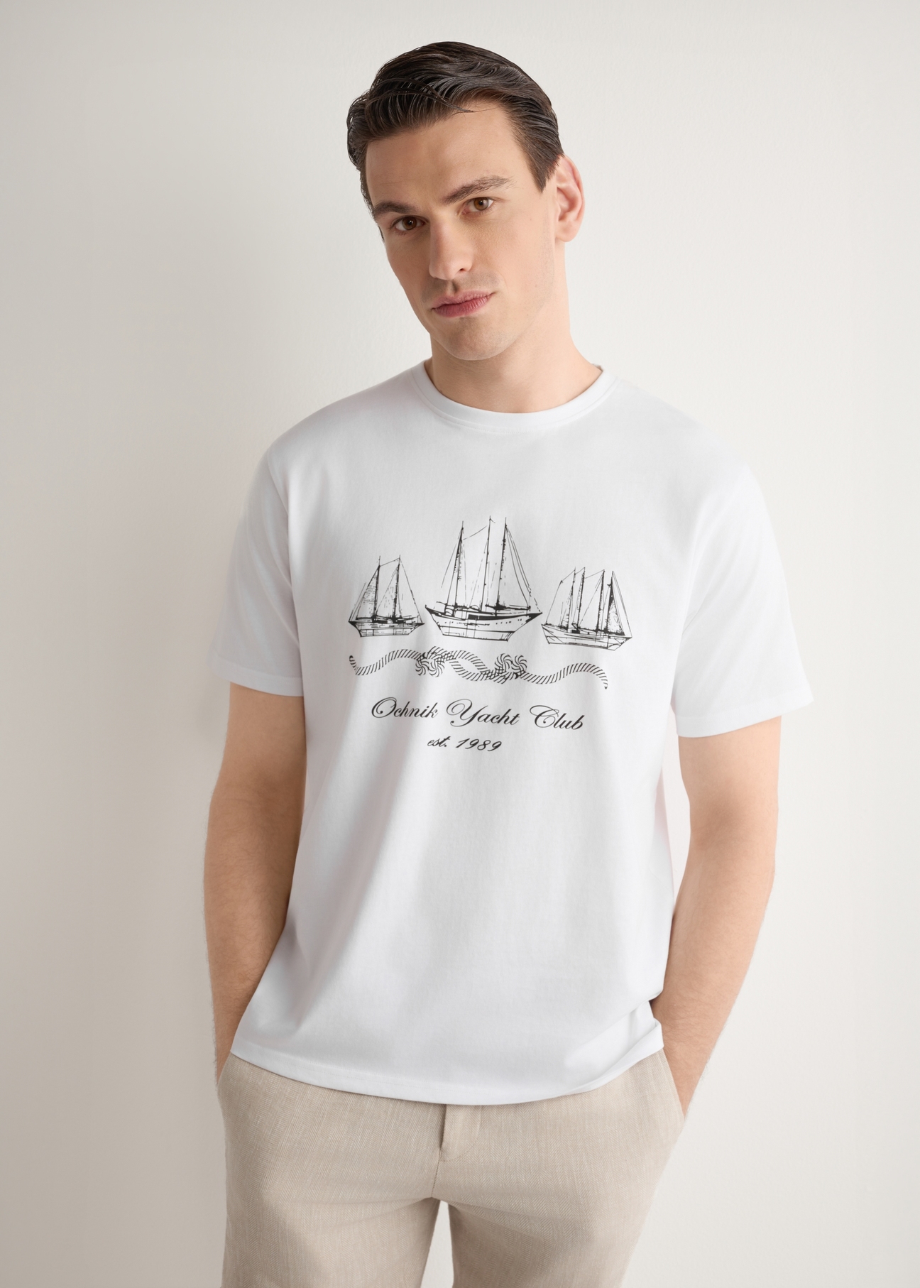 Men's white T-shirt with print TSHMT-0151-0B(W26), front view of the product on the model. Half of the silhouette visible.