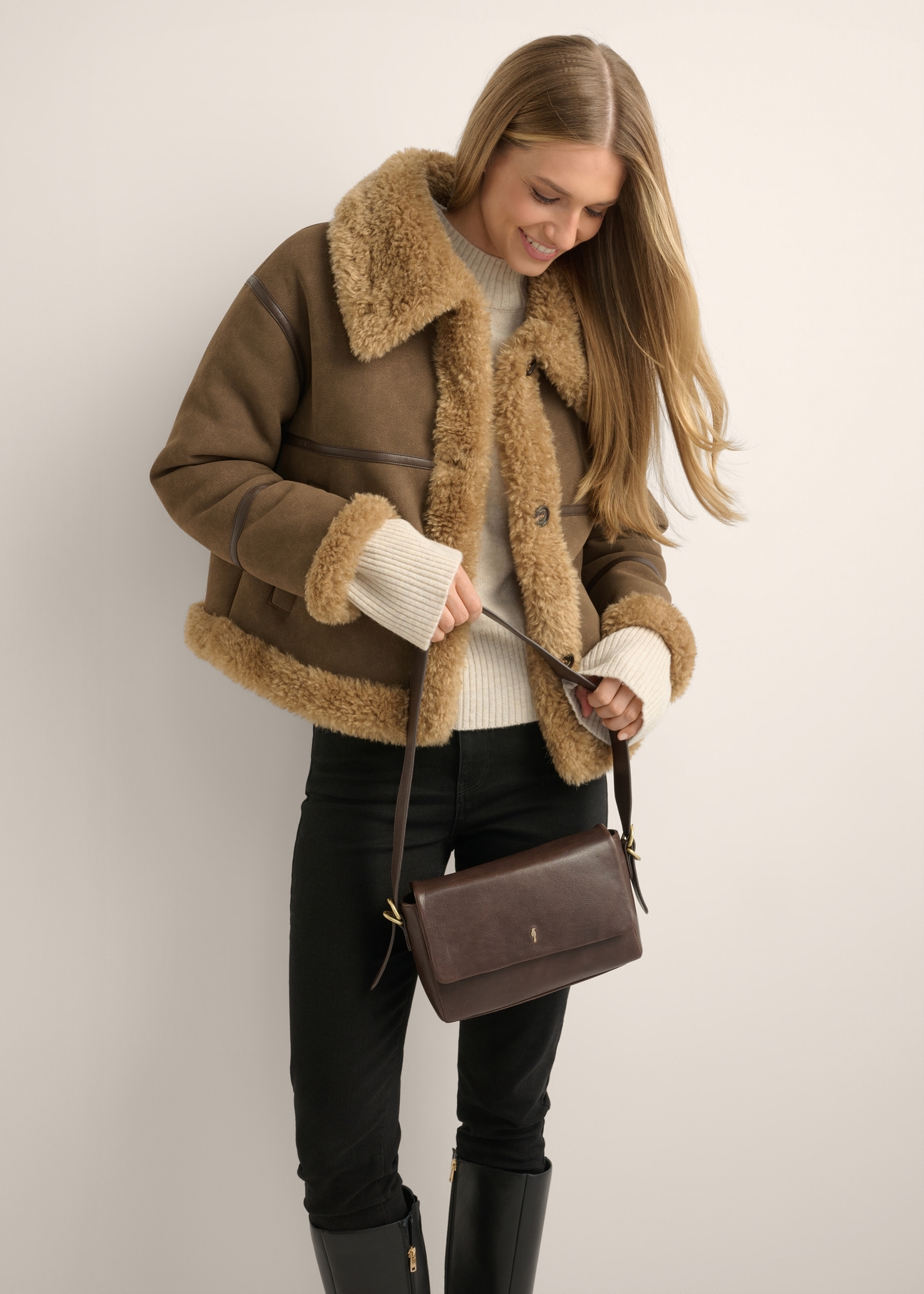 Brown leather women's handbag TORES-1377-1H(Z26), front view of the product on a model. Half of the silhouette visible.