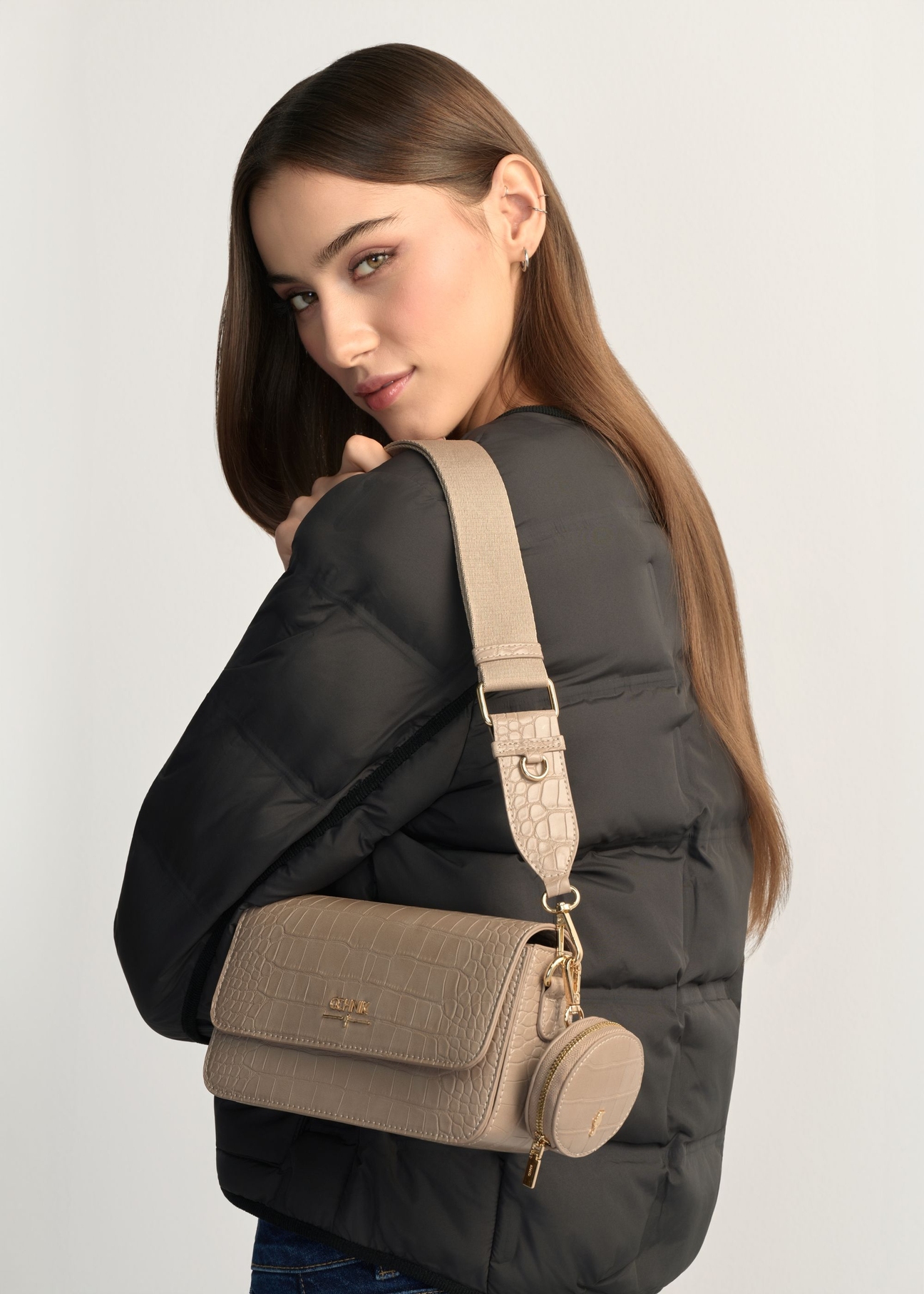 Small beige women's croco handbag TOREC-1171-1B(W26) - front view of the product, on a model, against a light background. Half of the silhouette visible.