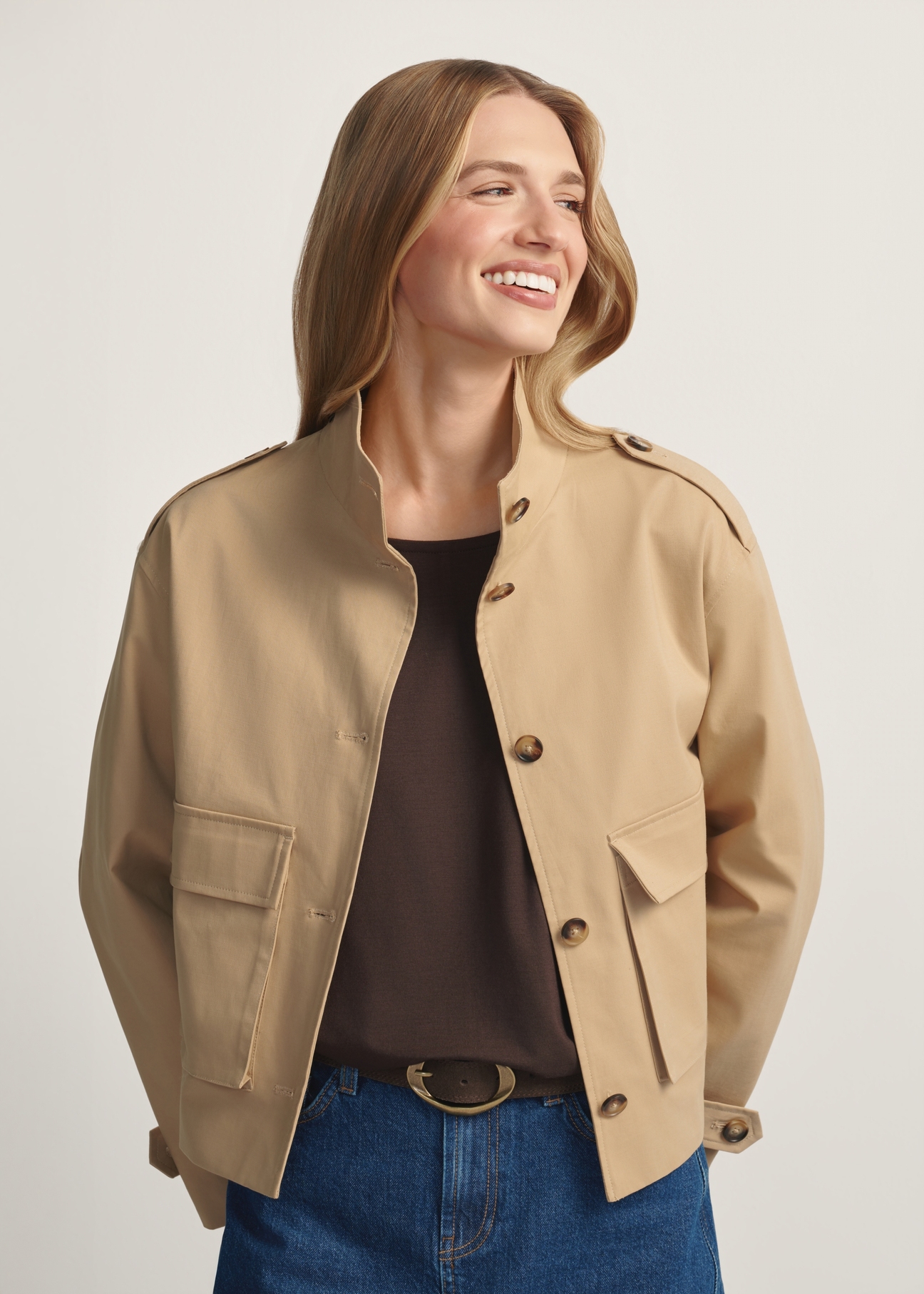 Beige women's transitional jacket KURDT-0628-1B(W26) - front view of the product, on a model, against a light background. Half of the silhouette visible.