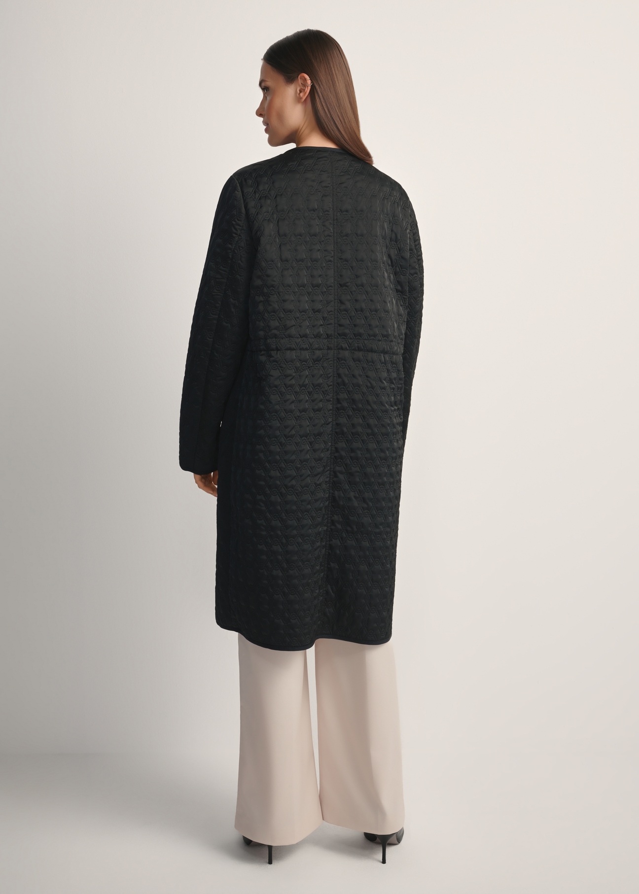 Women's black long quilted jacket KURDT-0631-99(W26) - back view of the product on a model, against a white background. Silhouette visible.