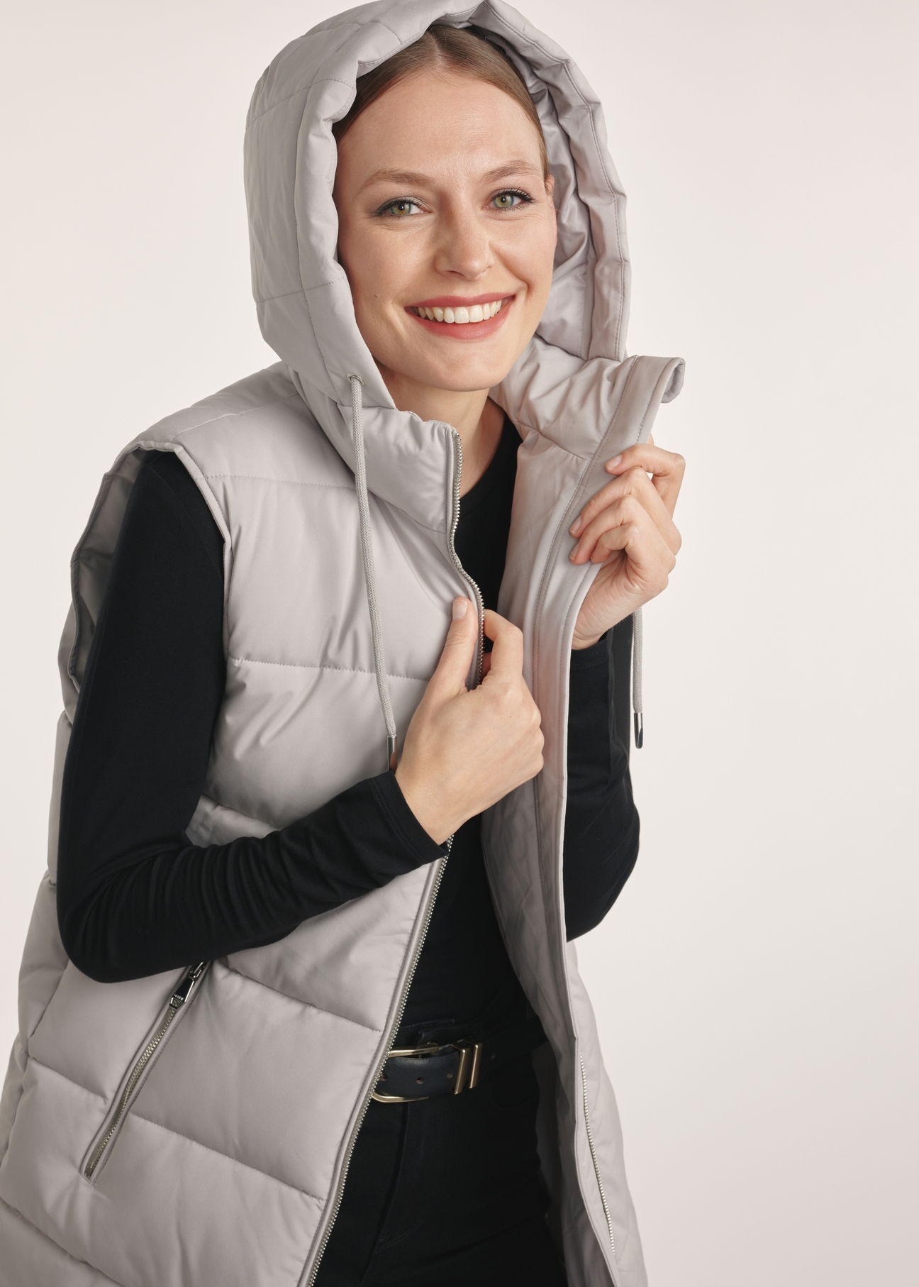 Gray long women's vest KAMDT-0034-91(Z25), side view of the product on the model, half of the silhouette visible.