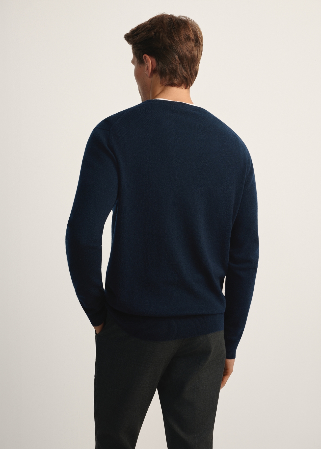Men's navy blue woolen cardigan with cashmere KARMT-0005-68(Z25), product view from the back on the model, half of the silhouette visible.