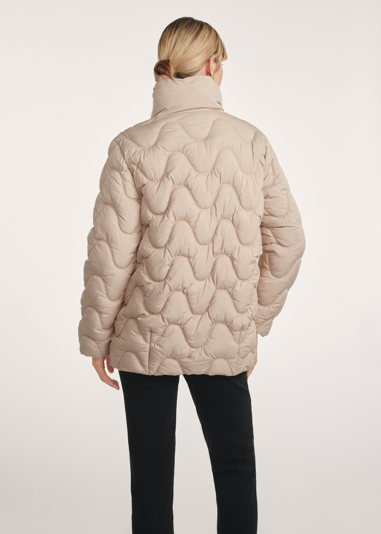 Beige women's quilted jacket KURDT-0606-81(Z25), product view from the back on the model. Half of the silhouette visible.