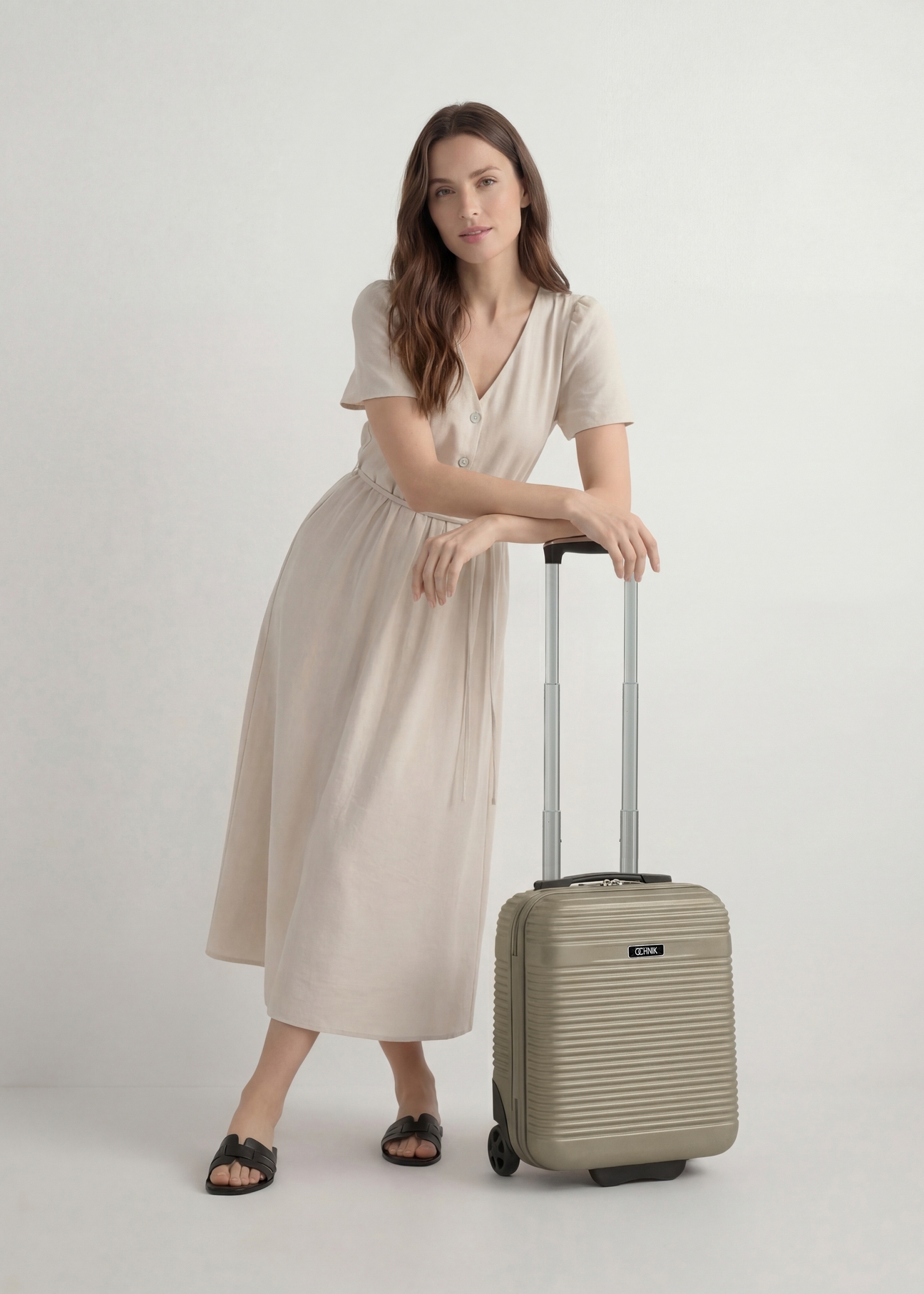 Cabin suitcase on wheels WALAB-0040-2X-16(W26), product view from the front next to the model, the whole silhouette is visible.