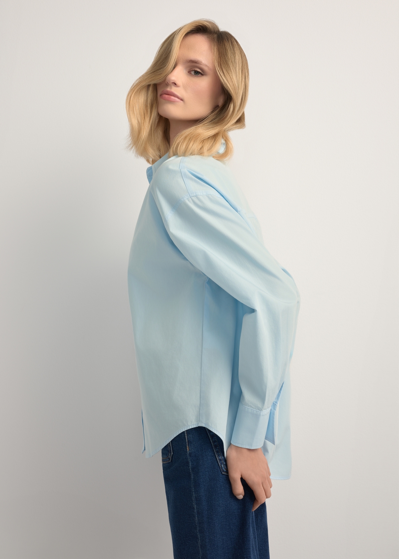 Blue cotton women's shirt KOSDT-0181-7A(W26), side view of the product on the model. Half of the silhouette visible.