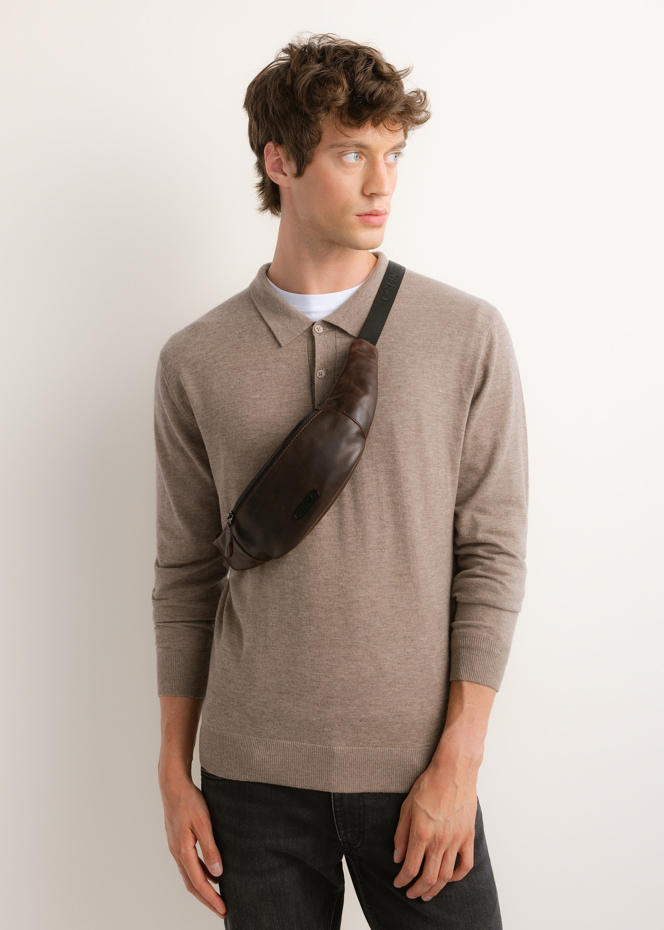 Men's brown leather waist bag TORMS-0543-1I(Z26), front view of the product on the model's silhouette.