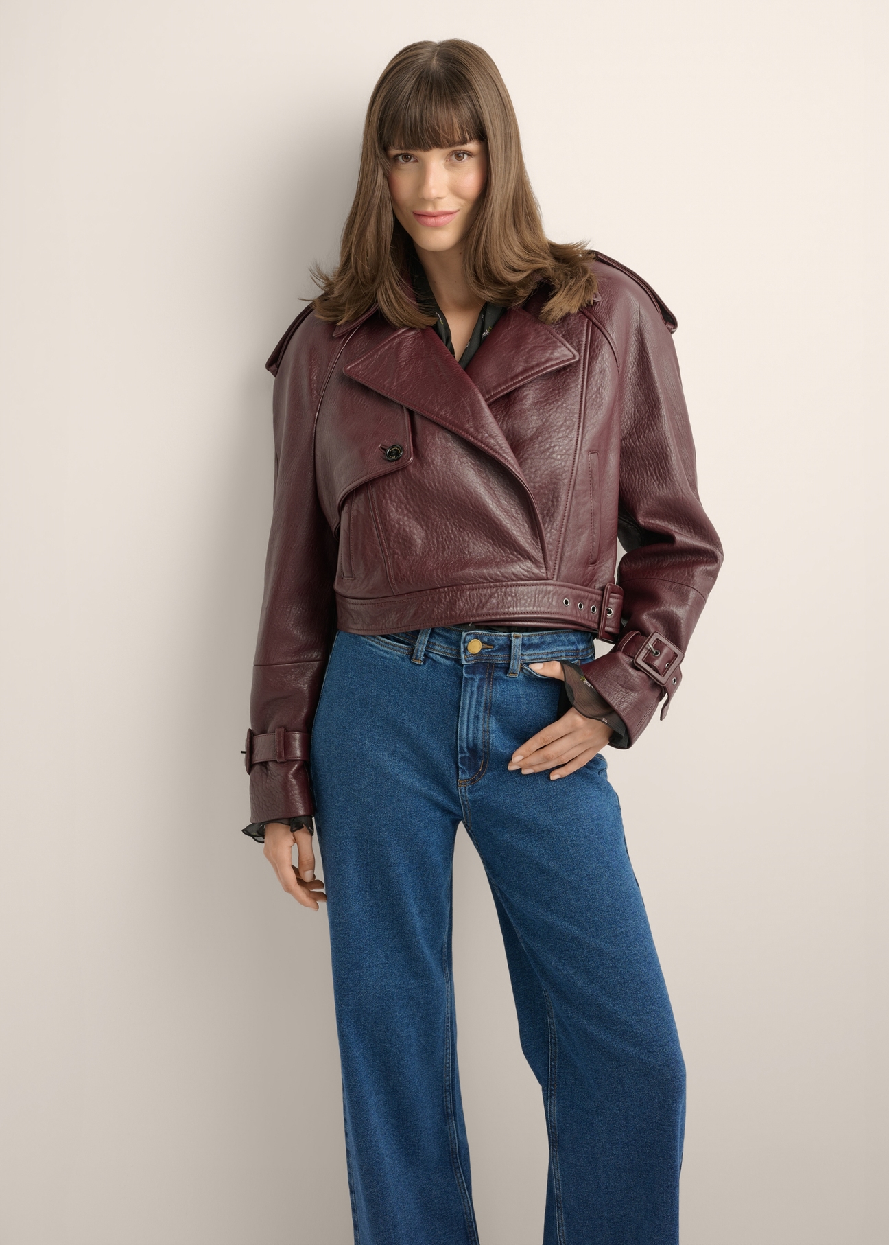 Burgundy women's short leather jacket KURDS-0615-4E(Z26), front view of the product on the model. Half of the silhouette visible.