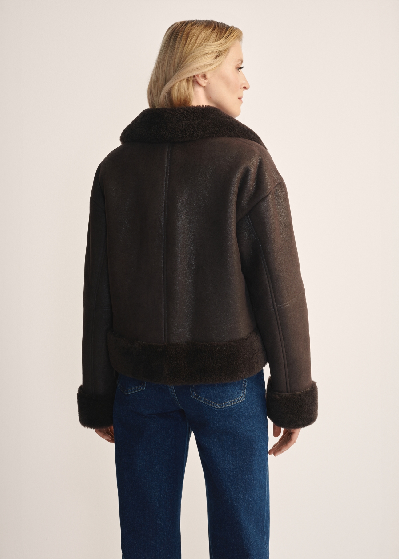 Women's brown leather sheepskin coat KOZDS-0096-3099(Z25) - back view of the product, on a model, against a white background. Knee-length silhouette visible.