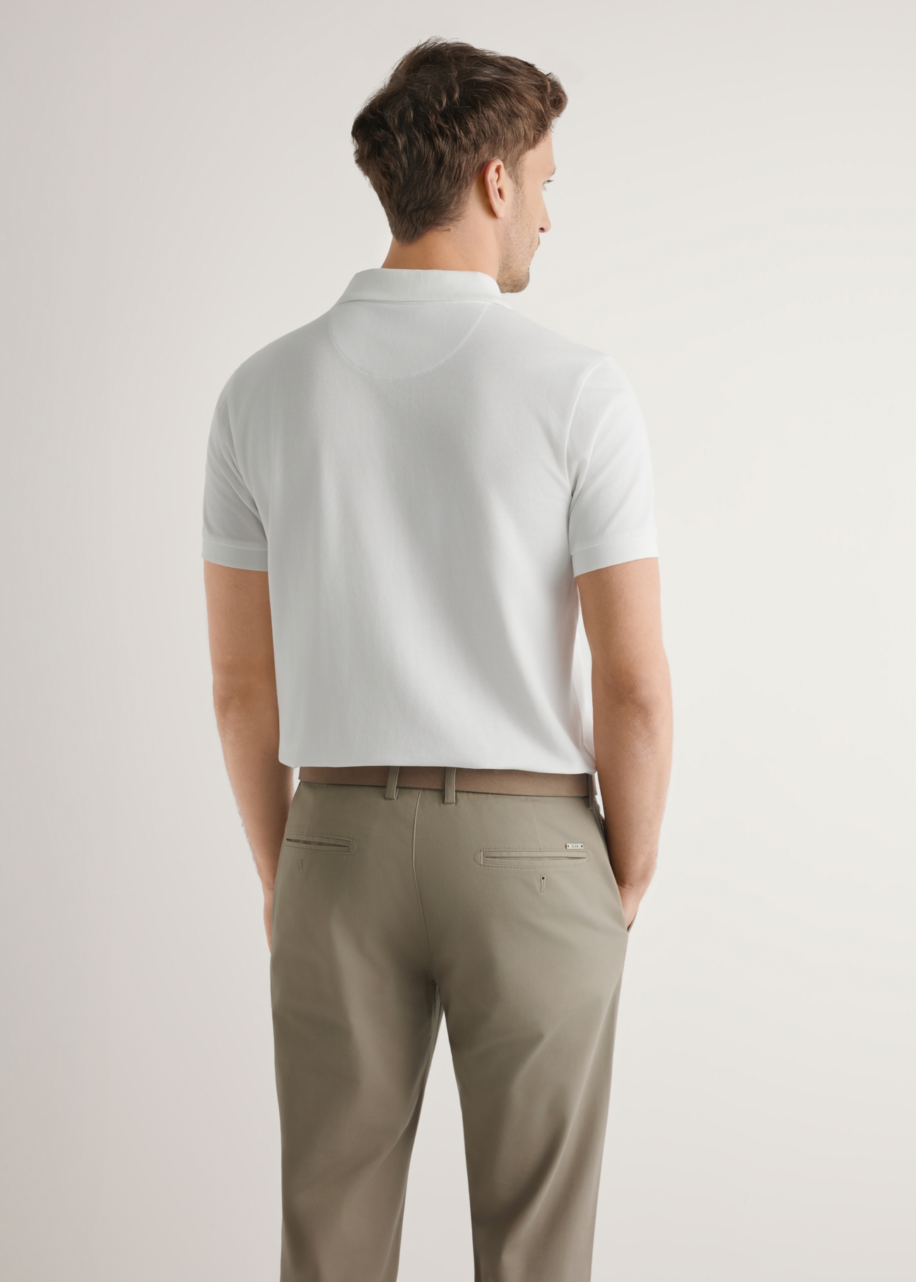 Cream cotton polo shirt POLMT-0086-0B(W26), back view of the product on the model. Half of the silhouette visible.