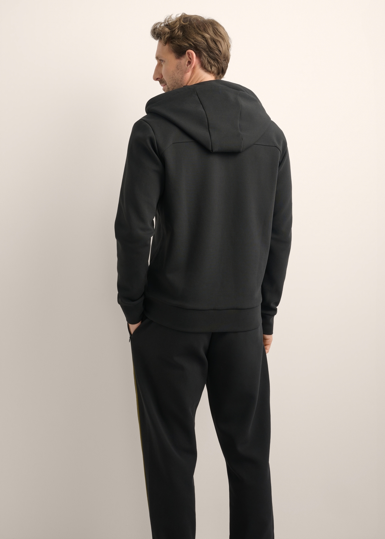 Men's black zip-up hoodie BLZMT-0083-99(Z26), product view from the back on the model. Half of the silhouette visible.