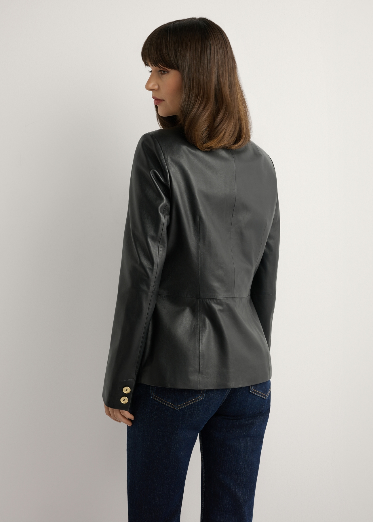 Women's black leather jacket KURDS-0445-99(W26), back view of the product on the model. Half of the silhouette visible.