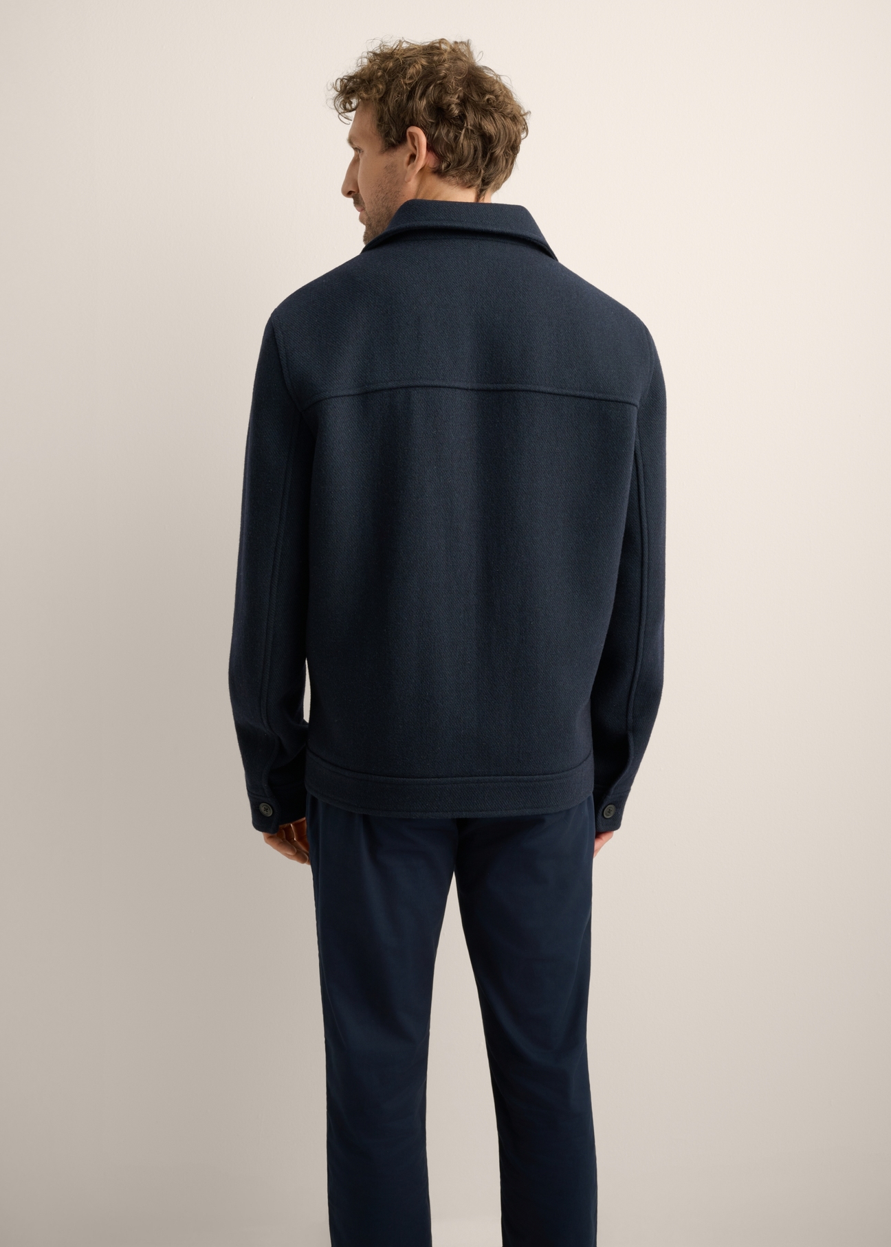 Navy blue men's wool coat PLAMT-0010-7D(Z26). Rear view of the product on a model. Half of the silhouette is visible.