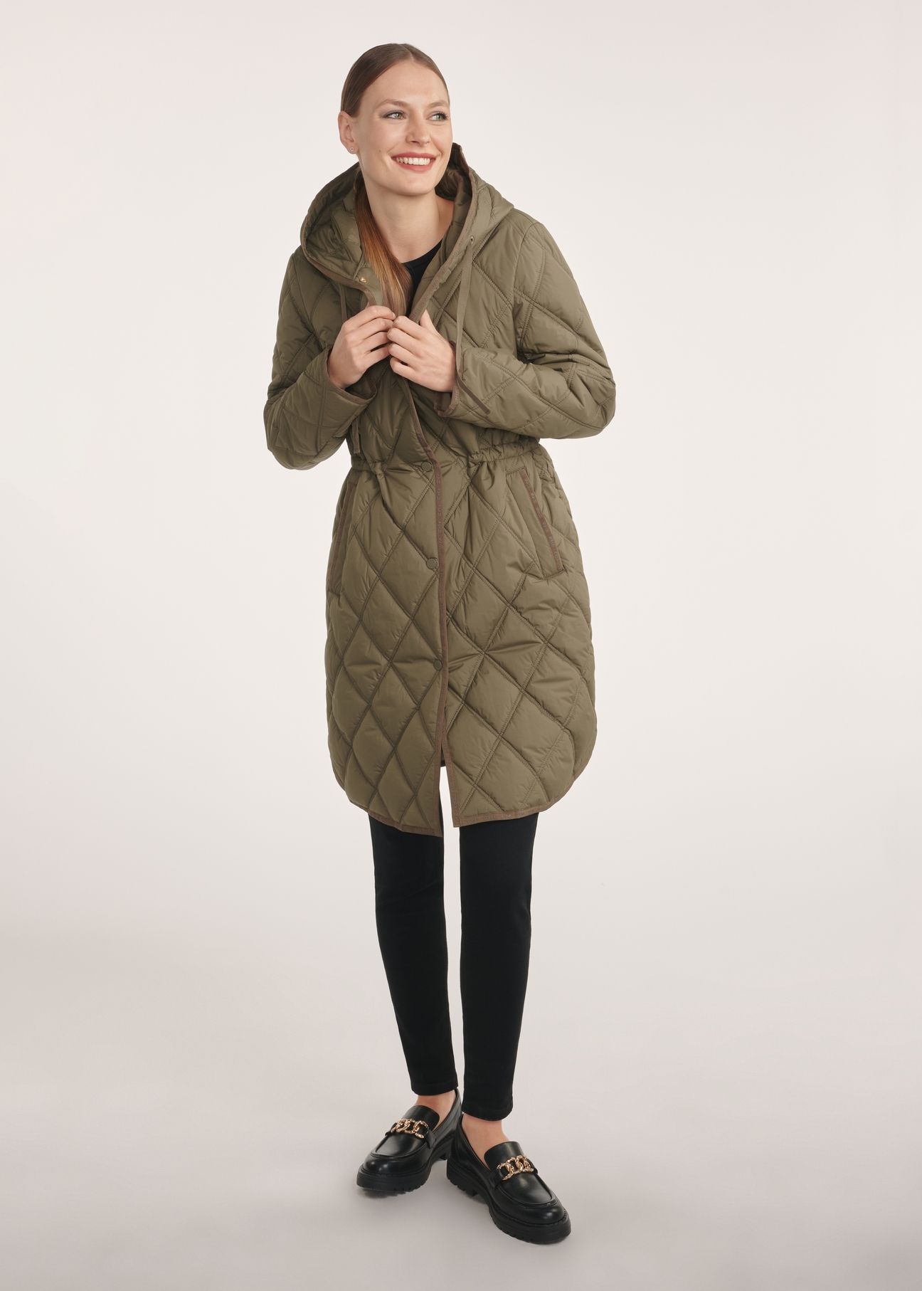 Olive quilted women's jacket KURDT-0579-57(Z25), front view of the product on the model, the entire silhouette is visible.