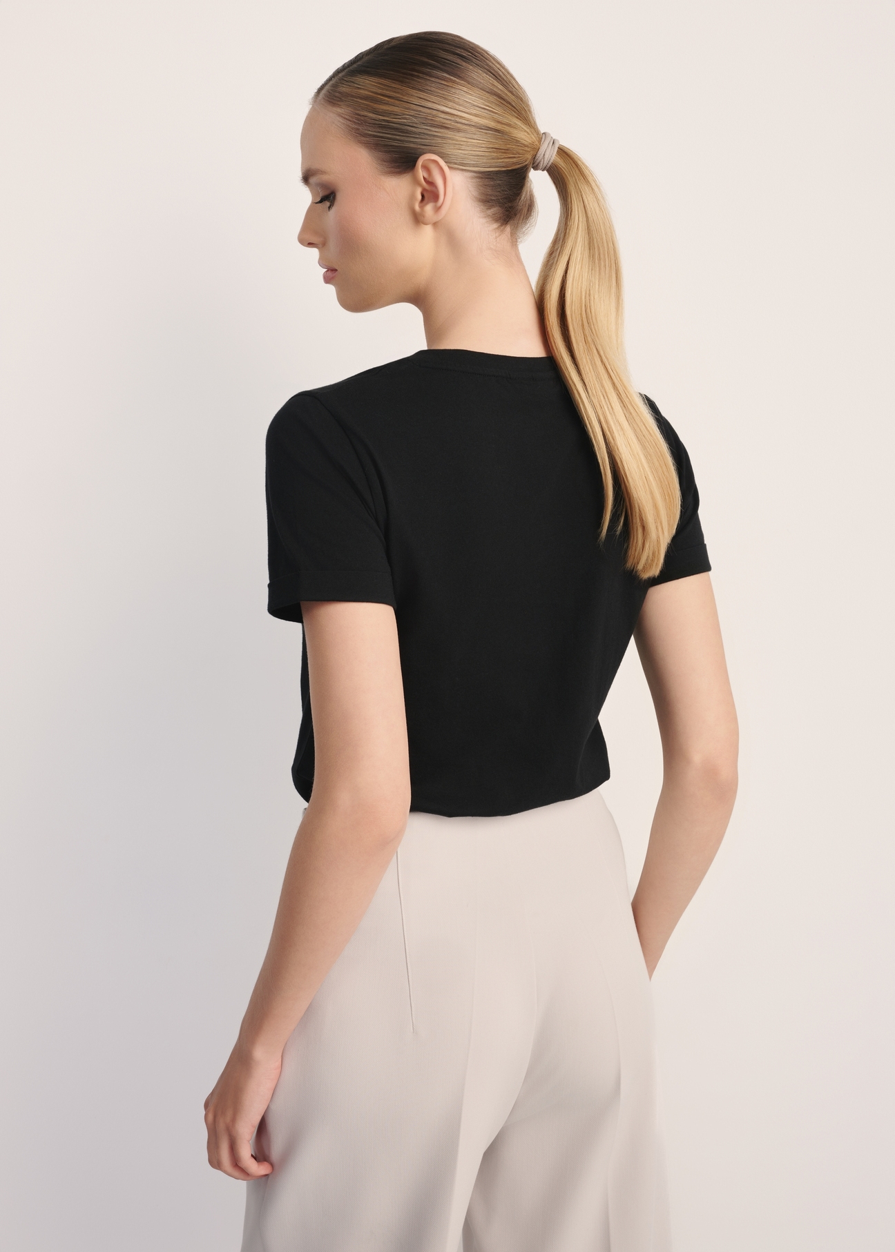 Black women's V-neck T-shirt TSHDT-0118A-99(Z25), product view from the back on the model. Half of the silhouette visible.