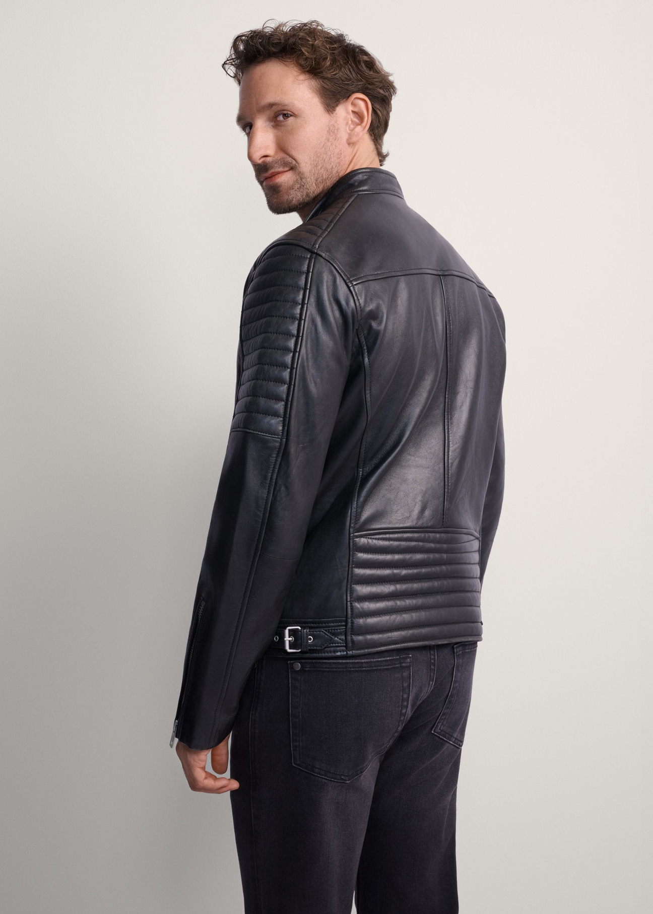 Men's leather biker jacket KURMS-0179L-5427(KS), rear view of the product on the model. Half of the silhouette visible.