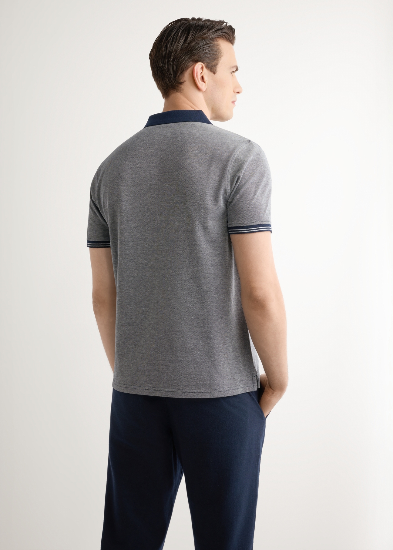 Men's navy blue polo shirt POLMT-0068-7E(W26), back view of the product on the model. Half of the silhouette visible.