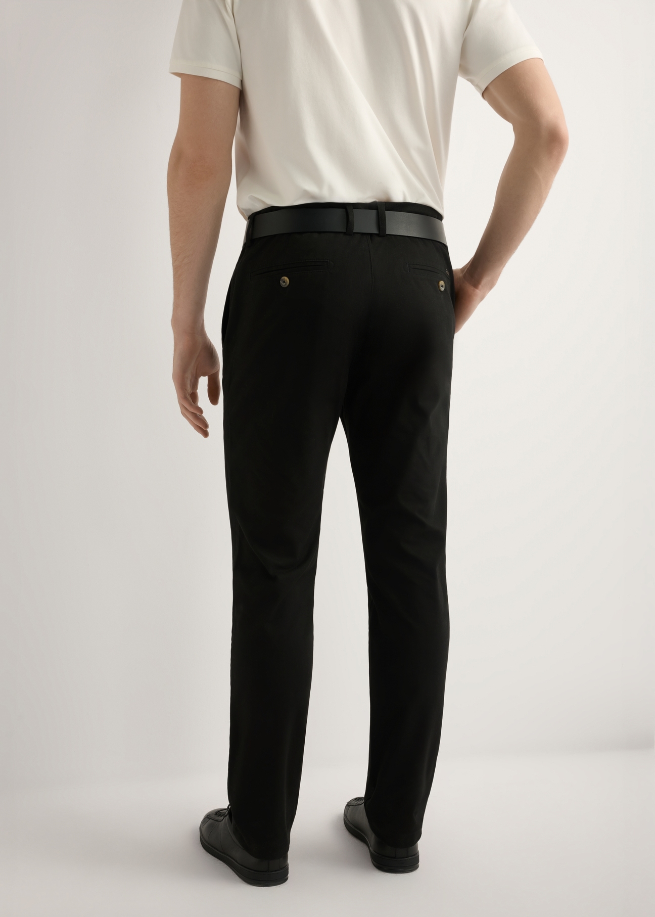 Black men's trousers SPOMT-0121-99(W26), product view from the back on the model, half of the silhouette visible.