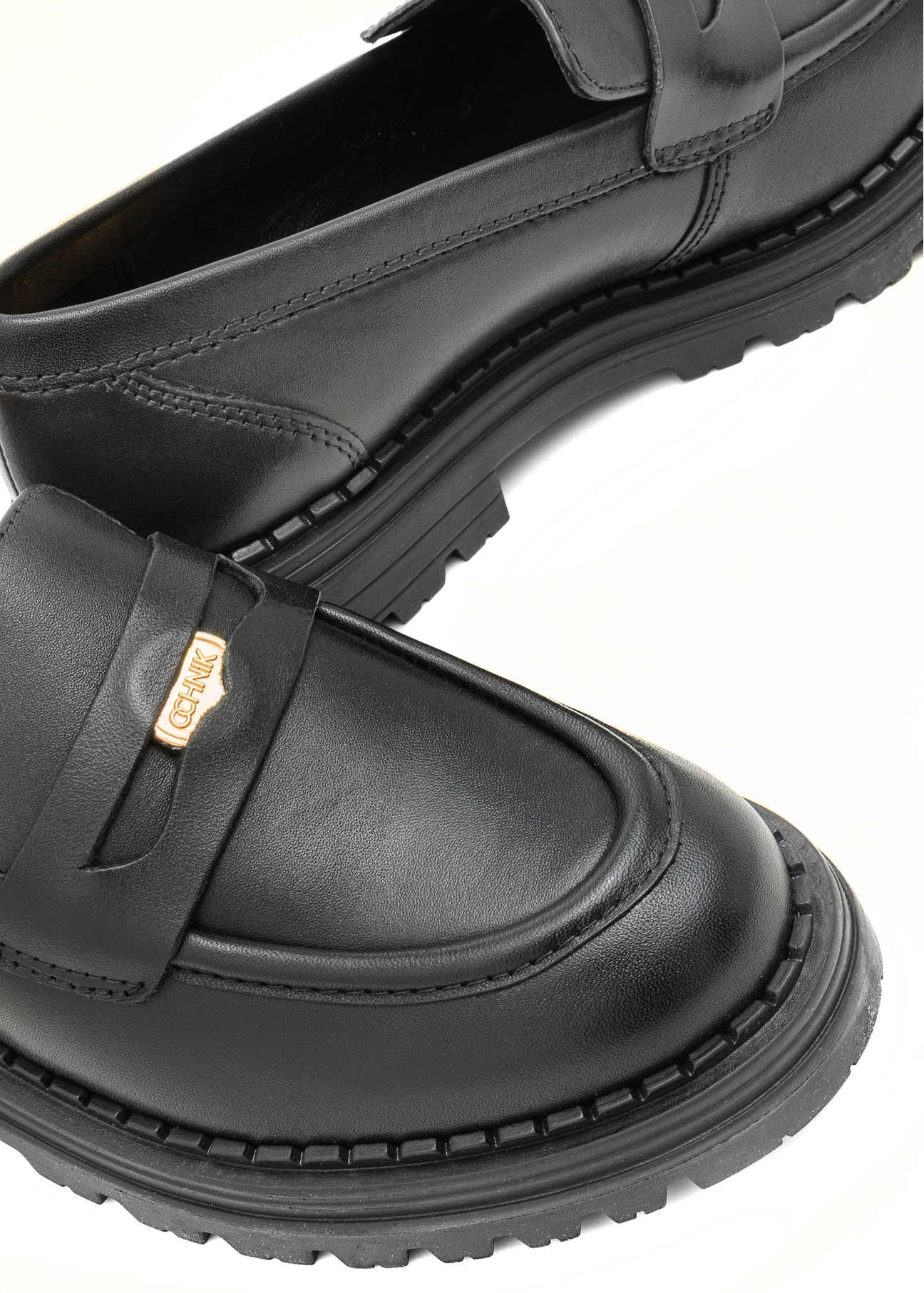 Women's leather black moccasins with logo BUTYD-1197-99(Z25), detail view of the product, view on a white background.