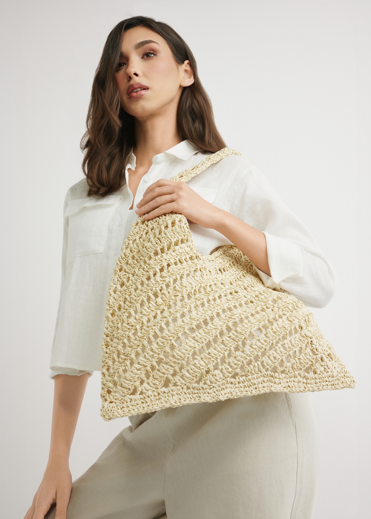 Beige women's natural straw handbag TOREC-1220-1E(W26) - product view from the bottom, slightly diagonal, against a light background. Half of the silhouette visible.