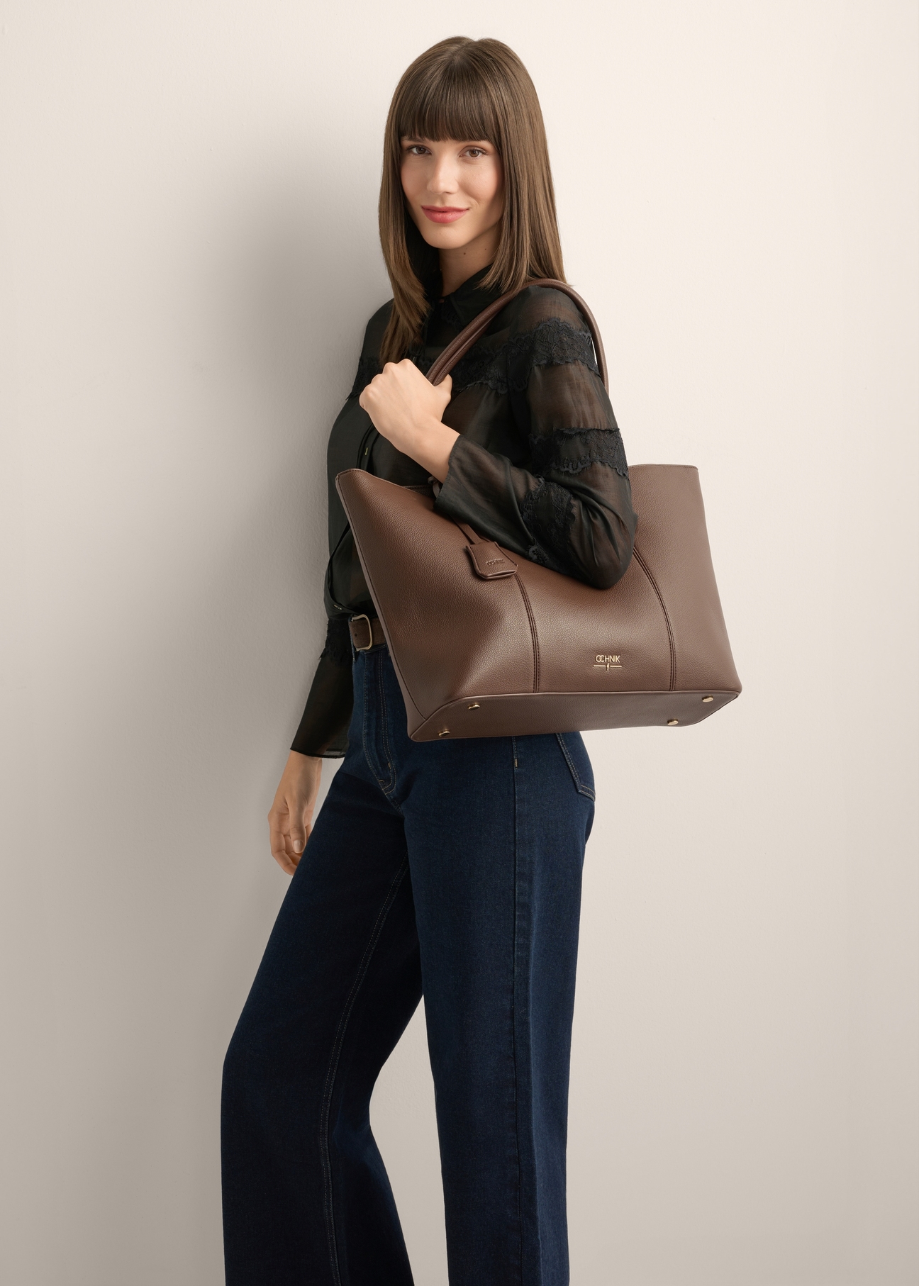 Women's brown shopper bag TOREC-1241-1H(Z26), product view on model's shoulder. Half of silhouette visible.