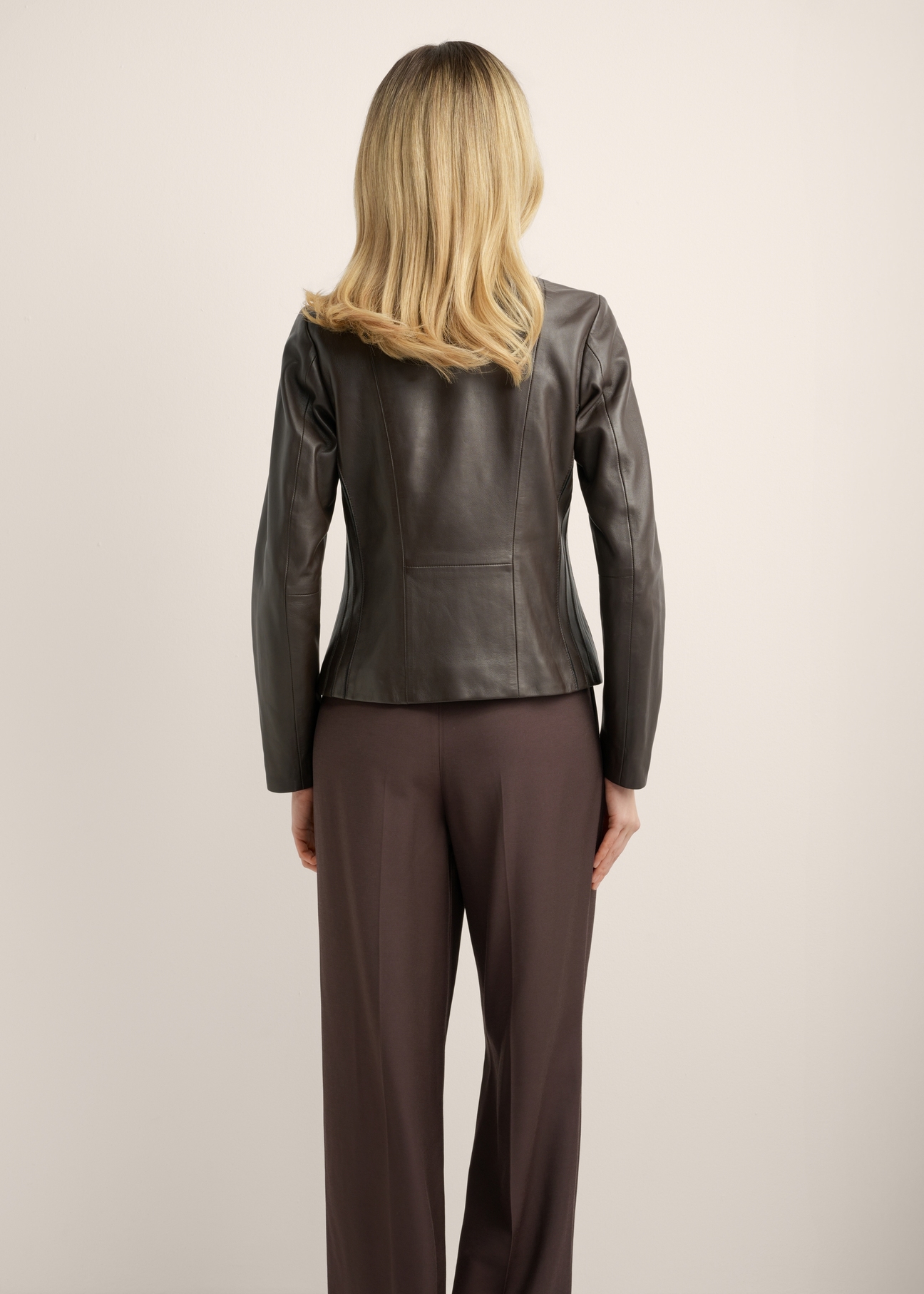 Brown women's leather jacket KURDS-0621-1I(KS), back view of the product on the model. Half of the silhouette visible.