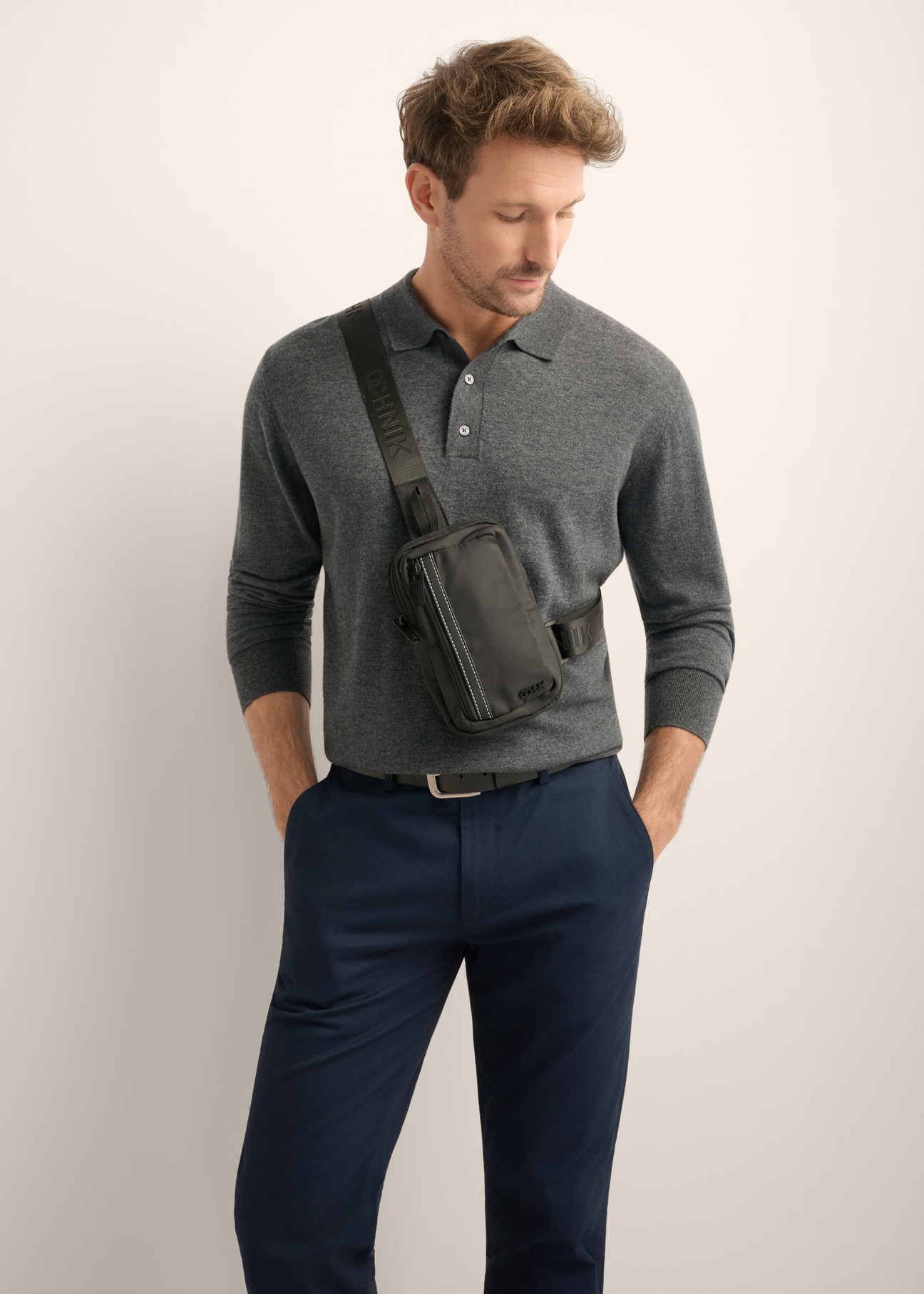 Men's black waist bag TORMN-0426-99(Z26), front view of the product on the model's silhouette, on a light background.