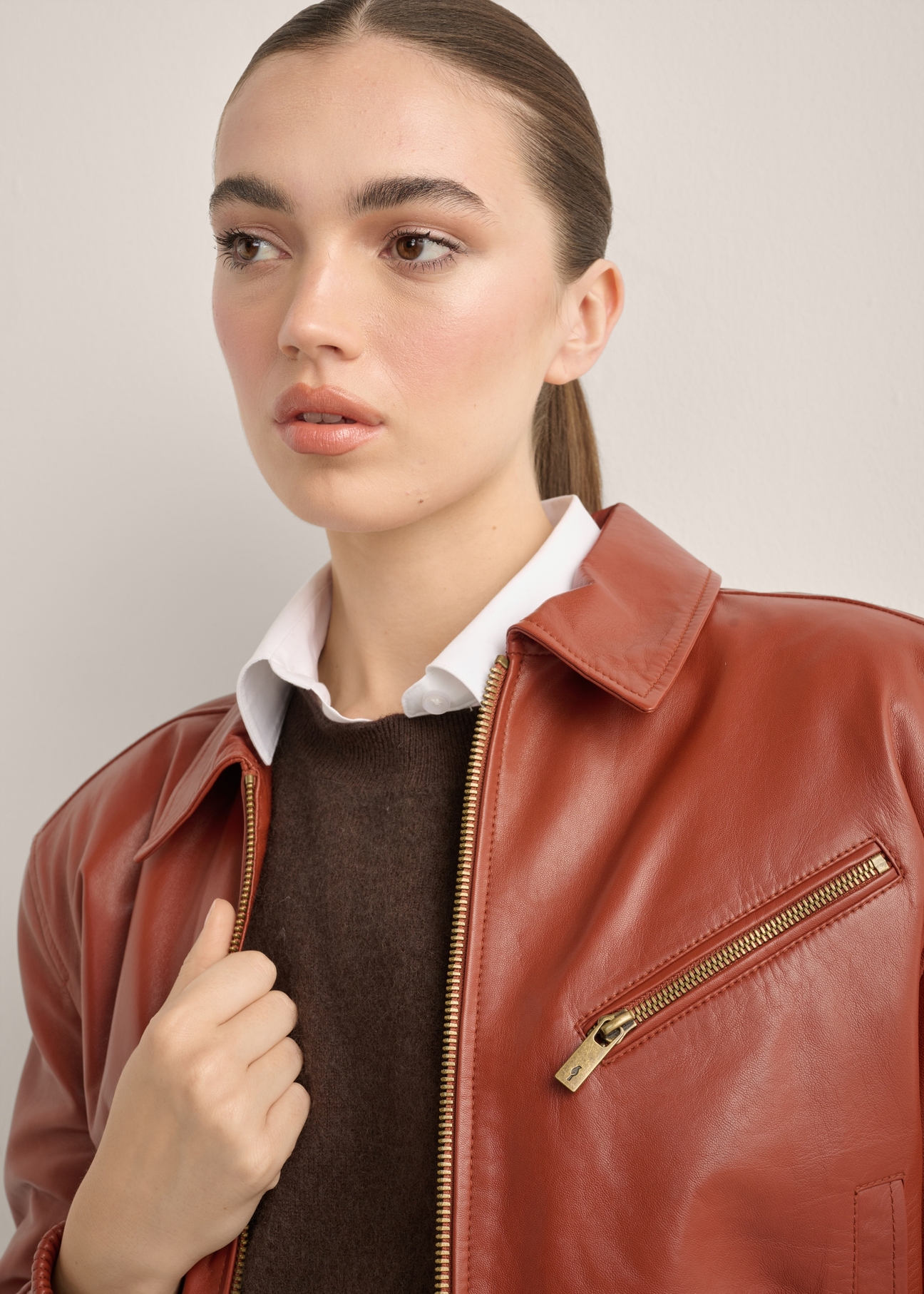 Women's red leather jacket KURDS-0624-3D(Z26), close-up of the product detail on the model. Torso visible.