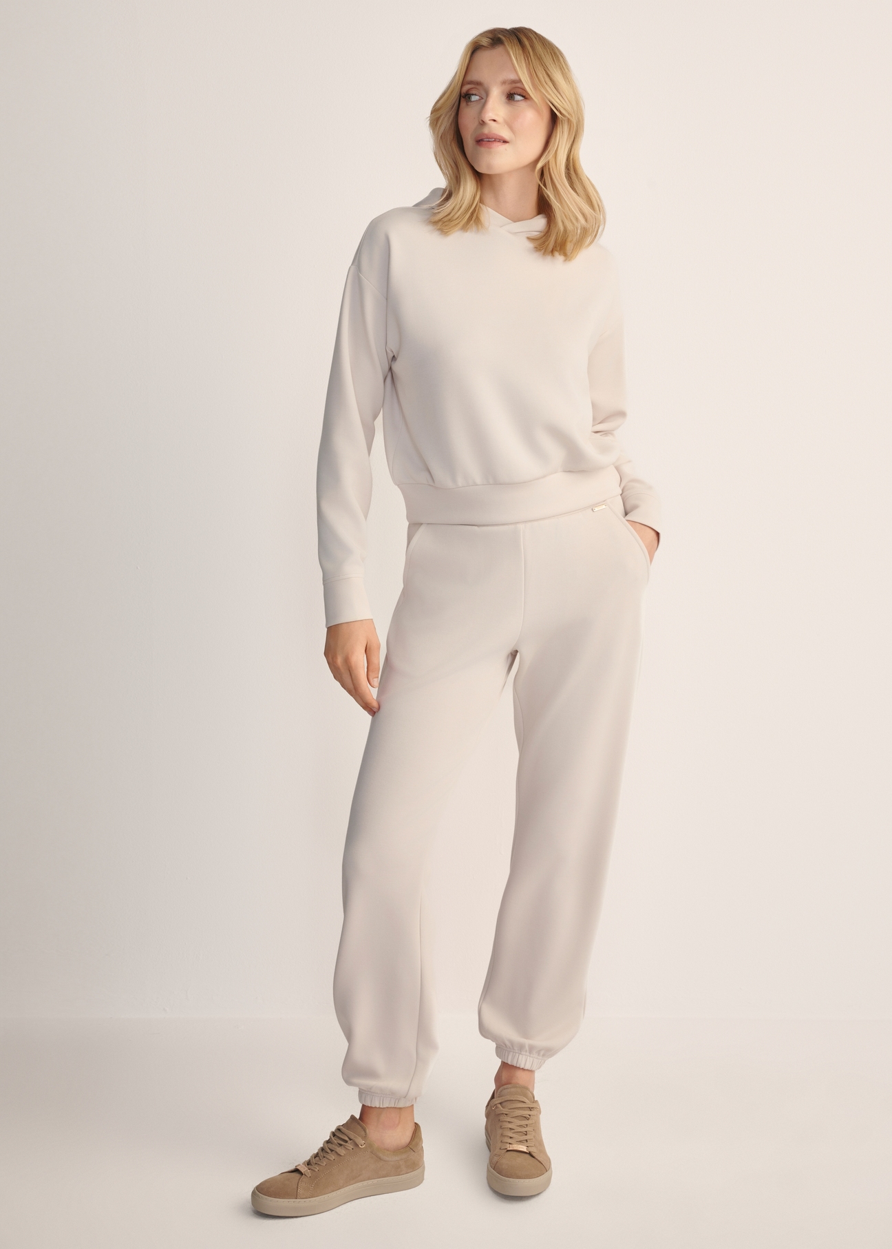 Light beige women's trousers SPODT-0117-80(Z25), front view of the product on the model. Full body visible.