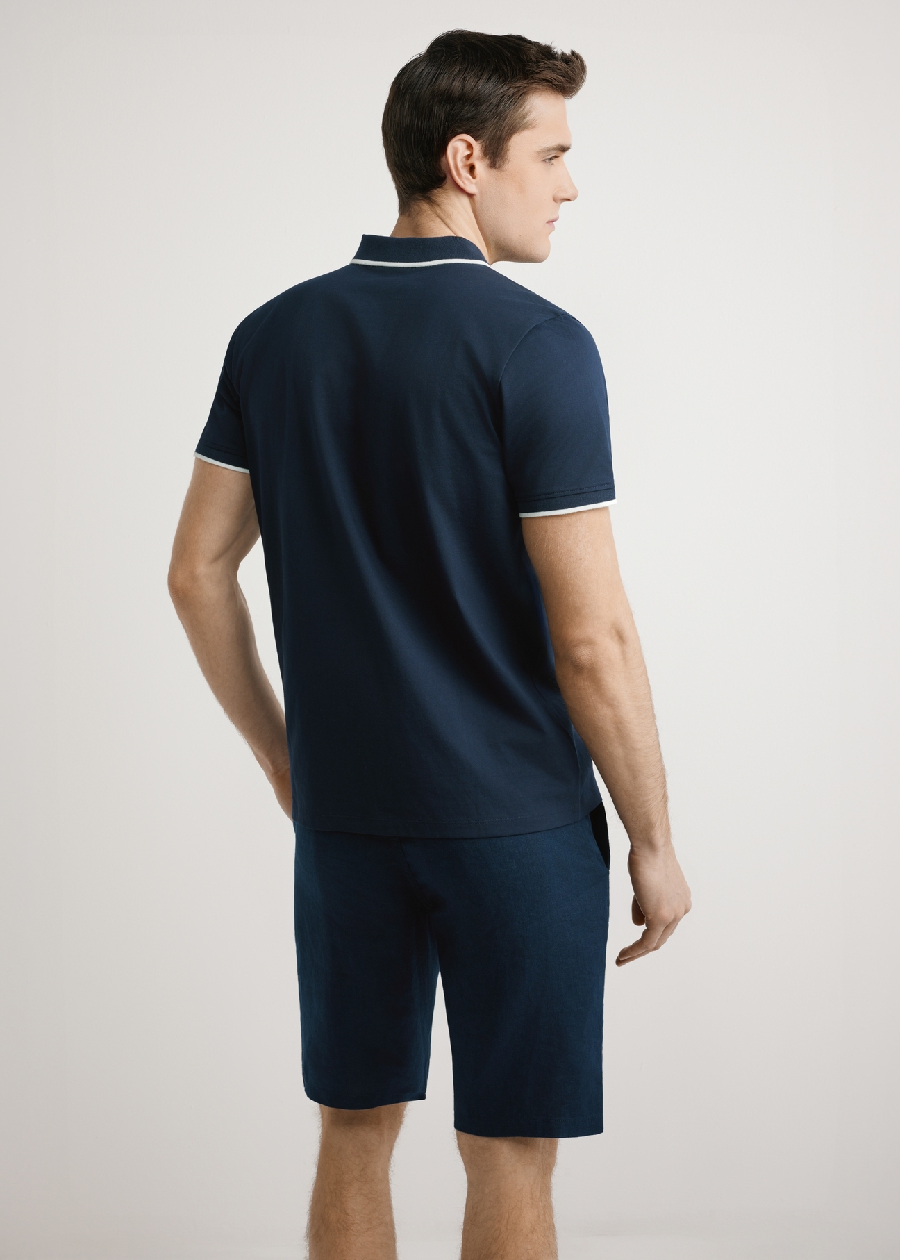 Men's dark navy polo shirt POLMT-0092-7E(W26), back view of the product on the model. Half of the silhouette visible.