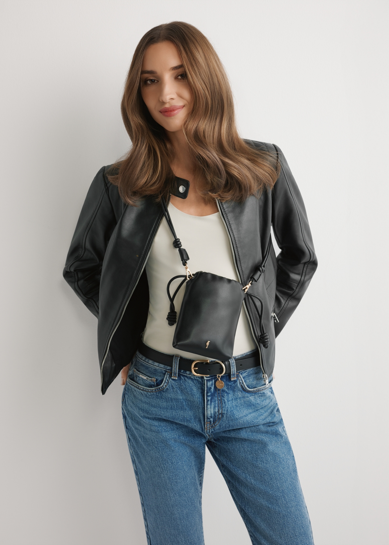 Black phone pouch TOREC-1216-99(W26) - front view of the product, on a model, against a light background. Half of the silhouette visible.